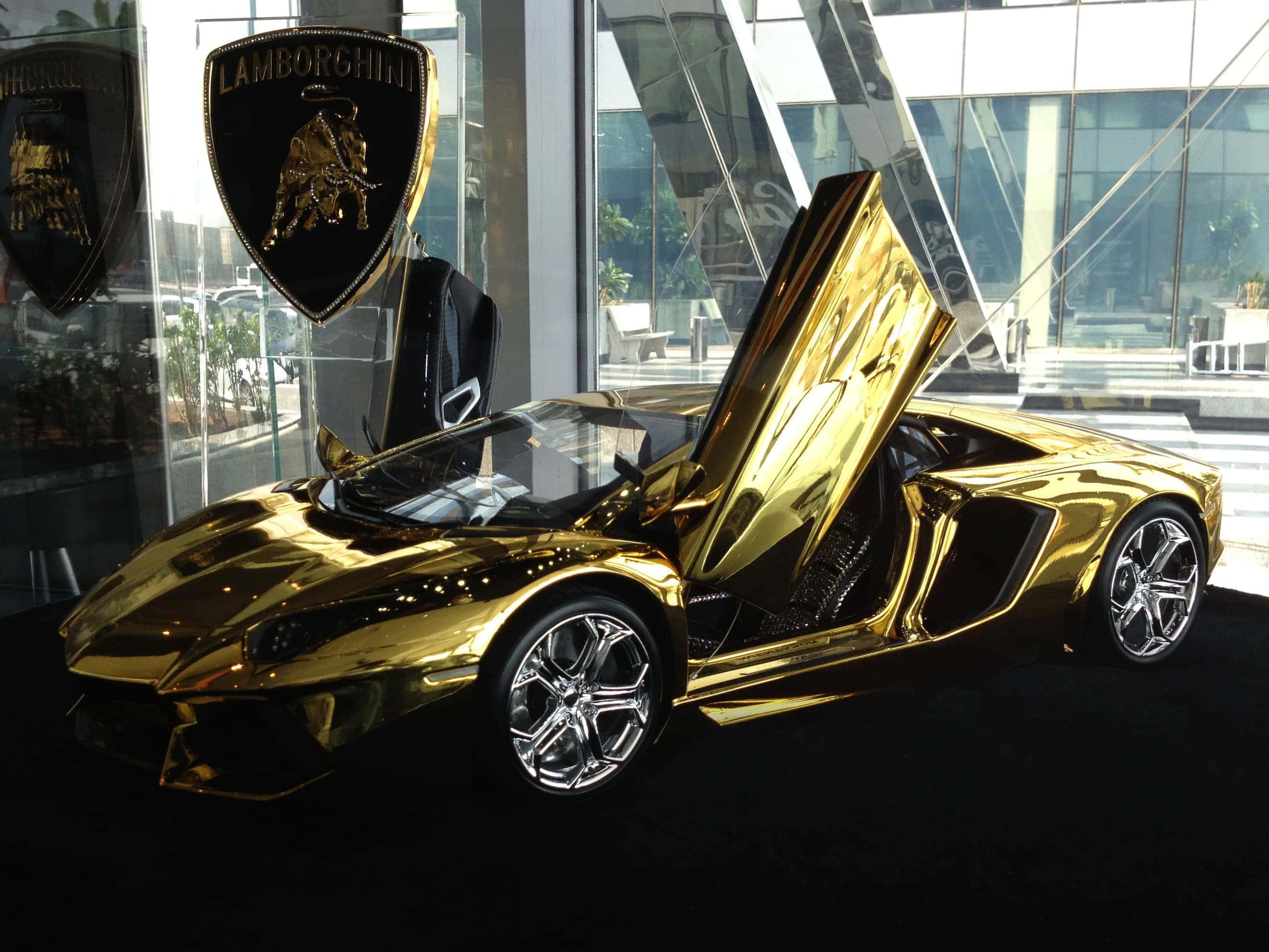 a gold lamborghini sports car is on display in a showroom — 2647x1986 wallpaper
