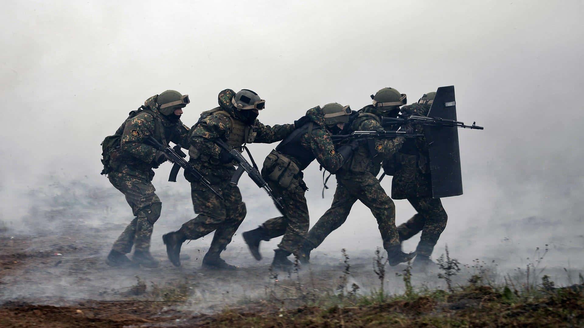 a group of soldiers are running through a field with smoke — 1920x1080 wallpaper
