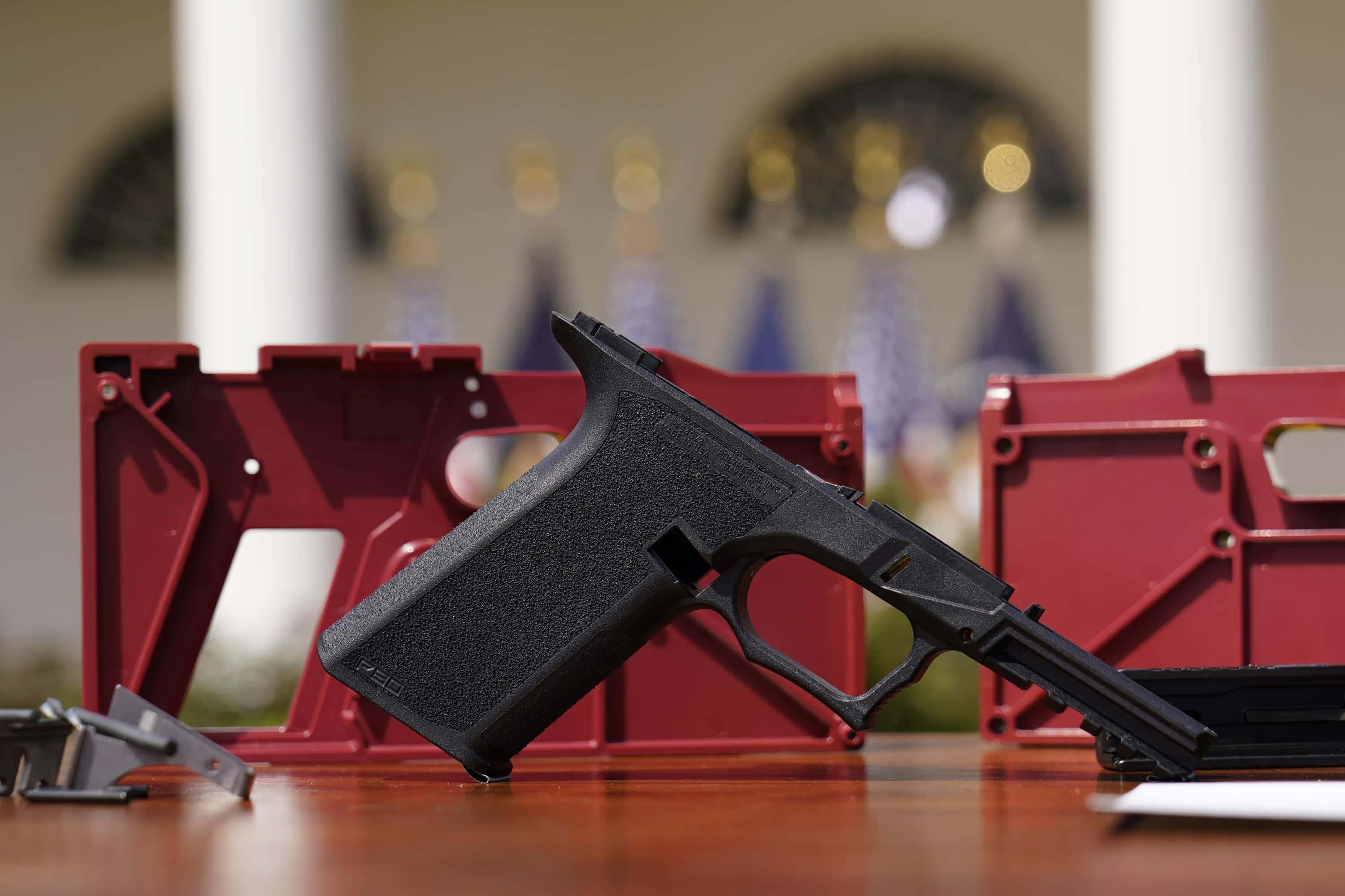 a gun is sitting on a table next to a white house — 3000x2000 wallpaper