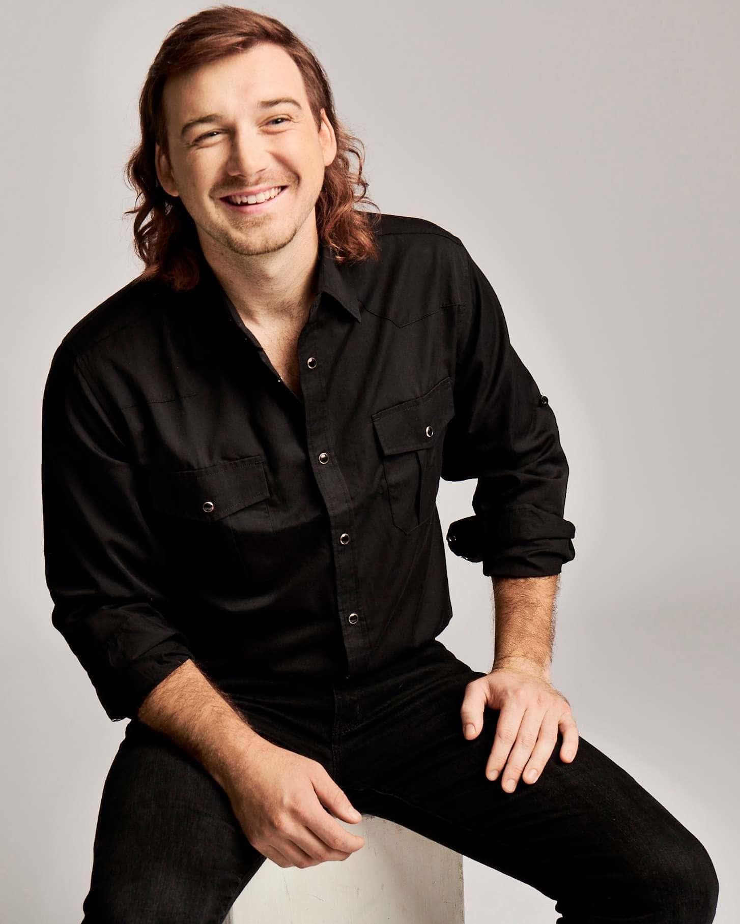 a man in a black shirt is smiling — 1454x1817 wallpaper