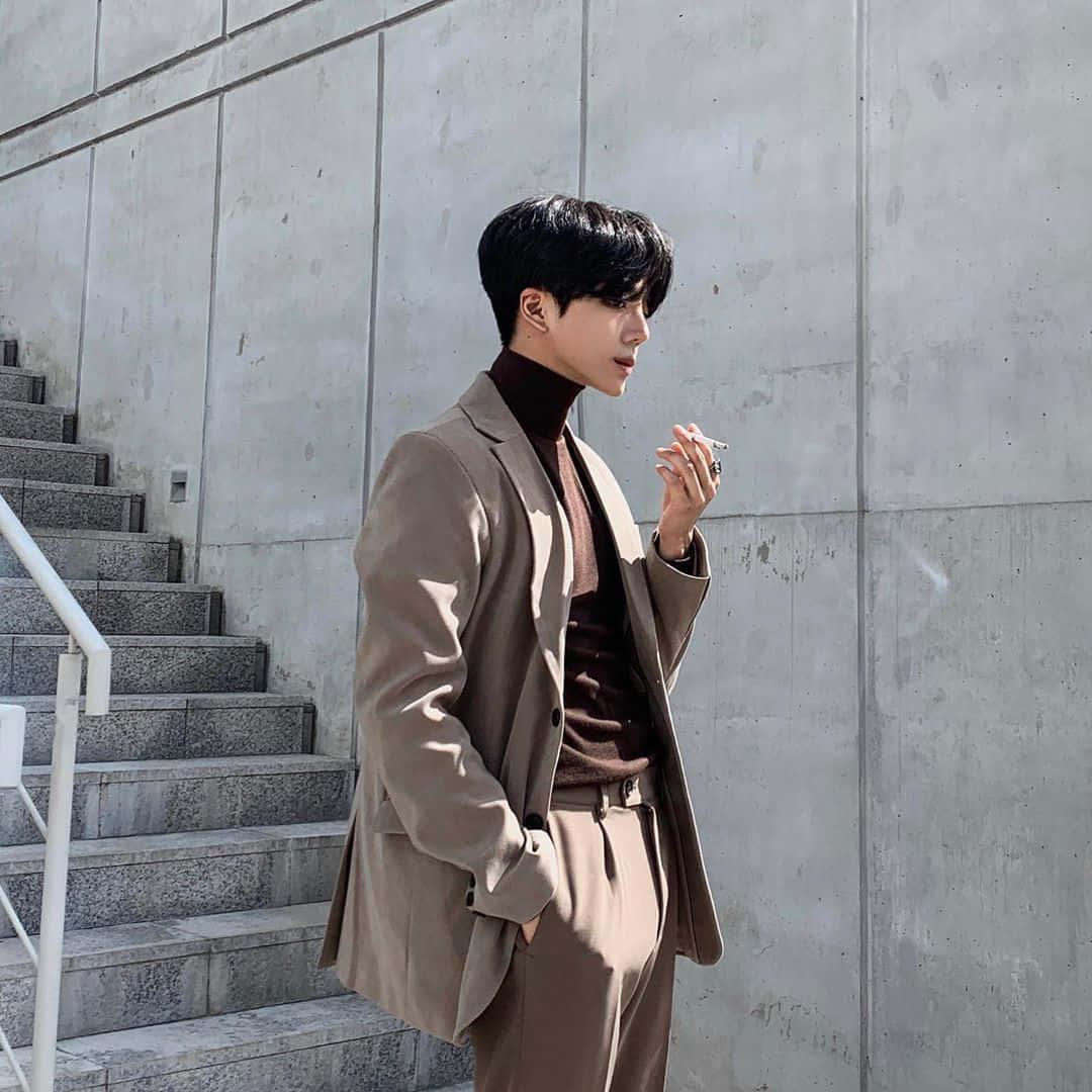a man in a brown suit standing on steps — 1080x1080 wallpaper