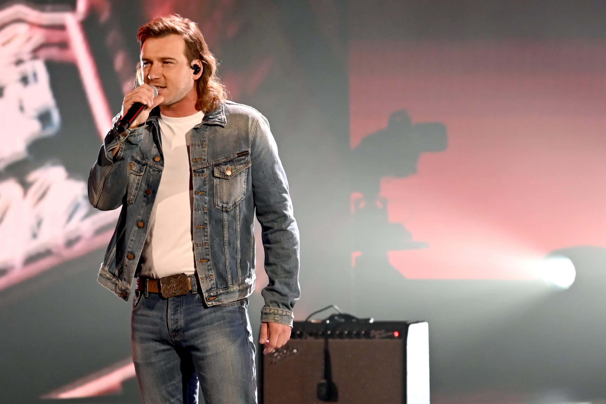 a man in a denim jacket singing into a microphone — 2560x1707 wallpaper