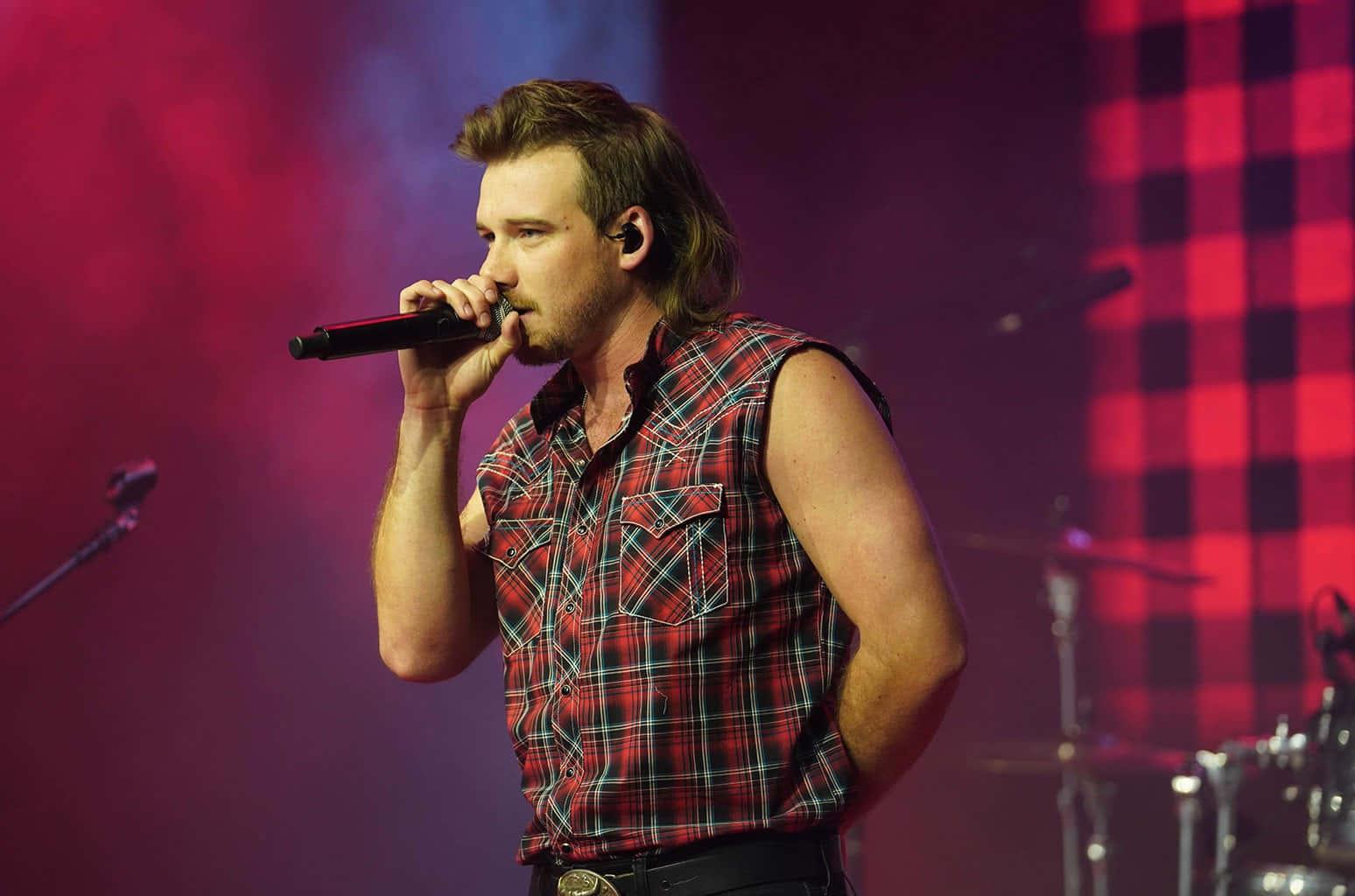 a man in a plaid shirt singing into a microphone — 1548x1024 wallpaper