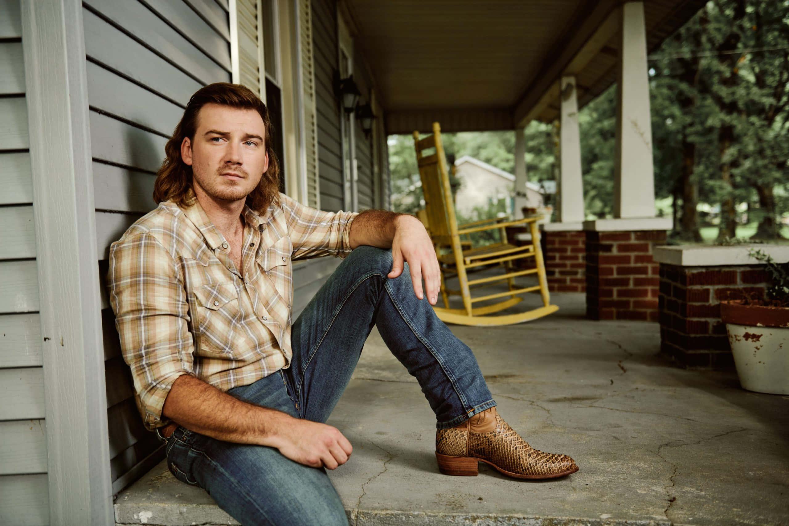 a man in jeans and boots sitting on the porch — 2560x1707 wallpaper
