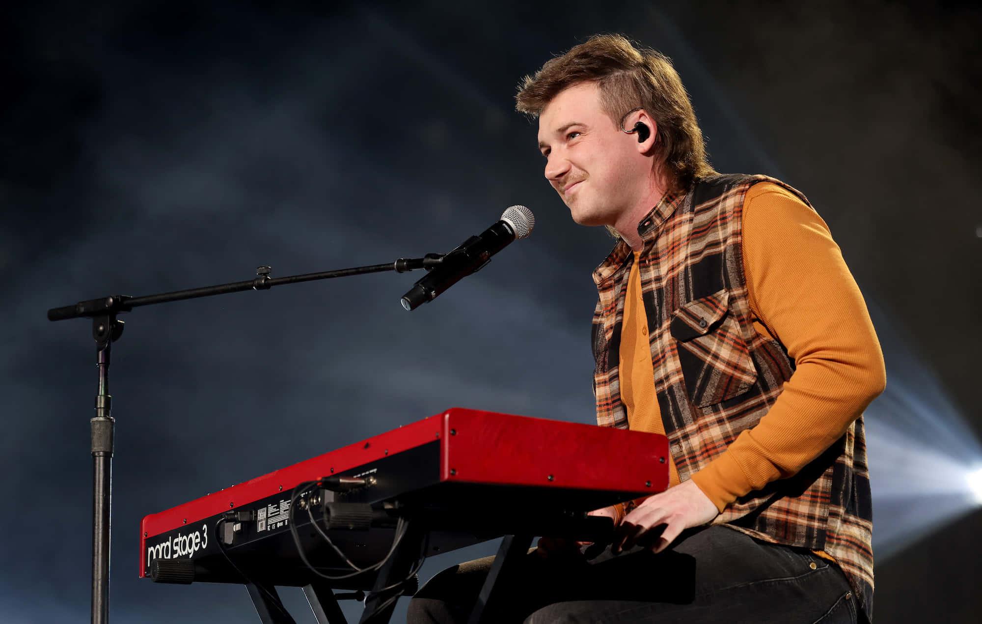 a man playing a keyboard while singing — 2000x1270 wallpaper