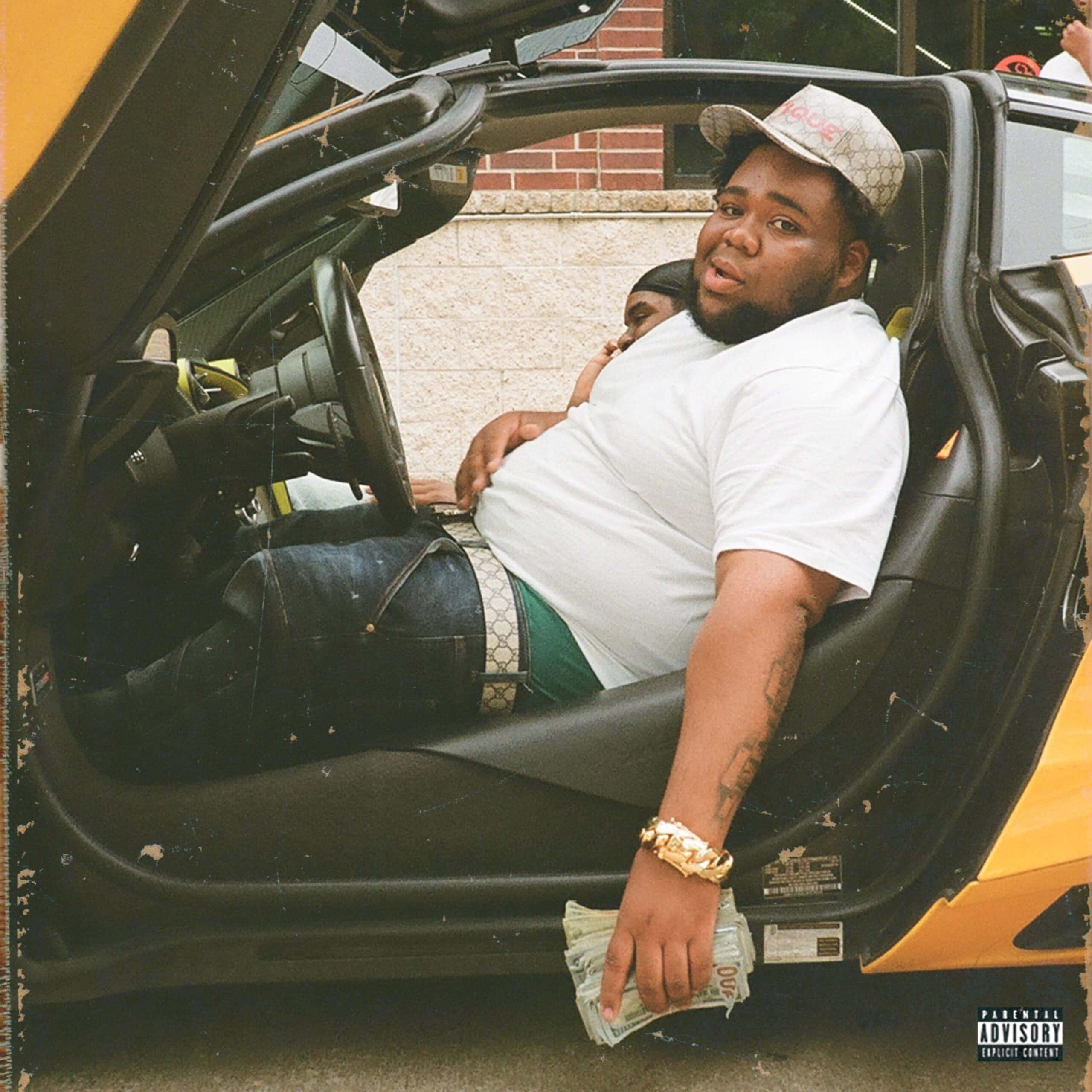 a man sitting in the back seat of a yellow car — 2560x2560 wallpaper