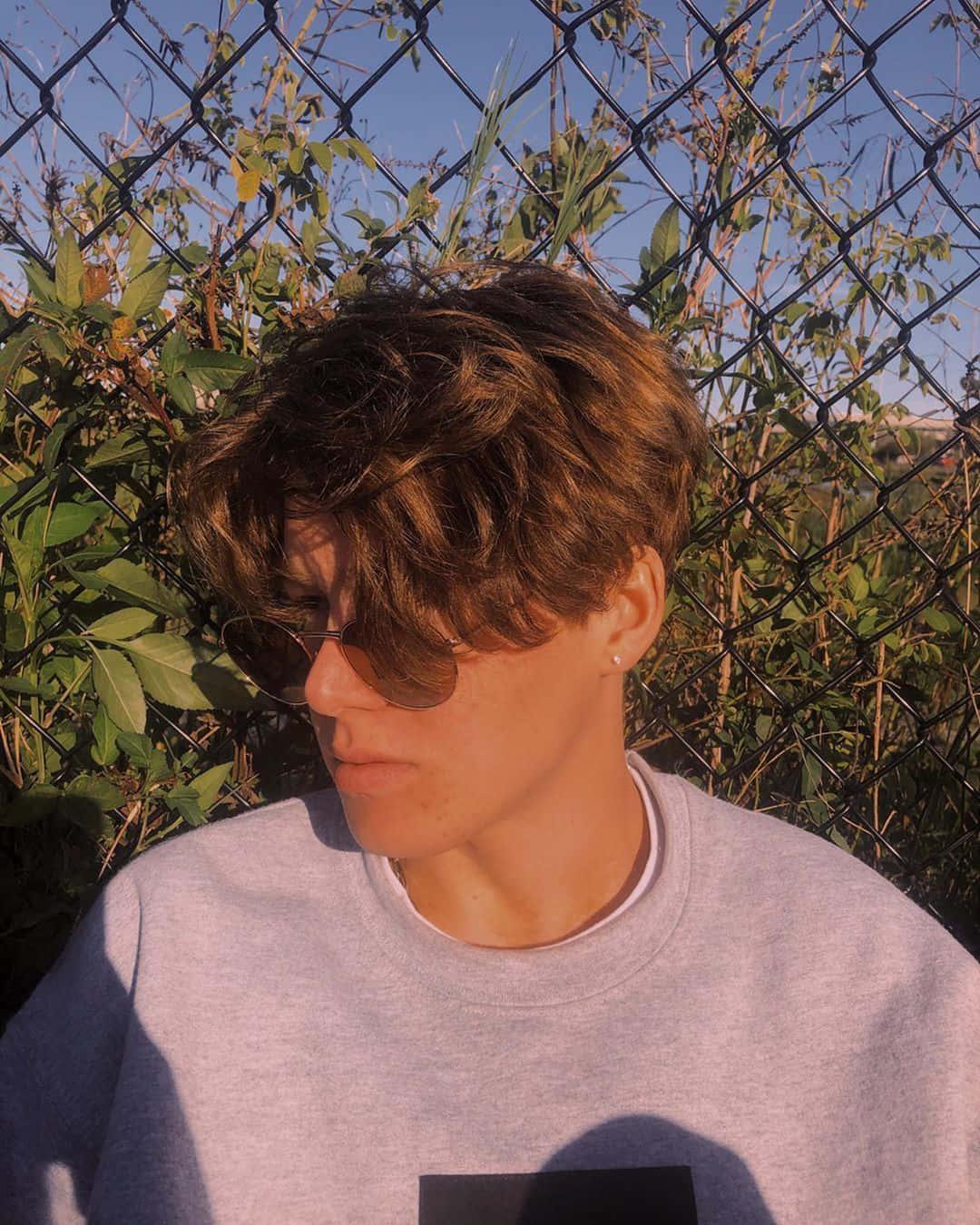 a man wearing sunglasses and a sweatshirt — 1080x1350 wallpaper