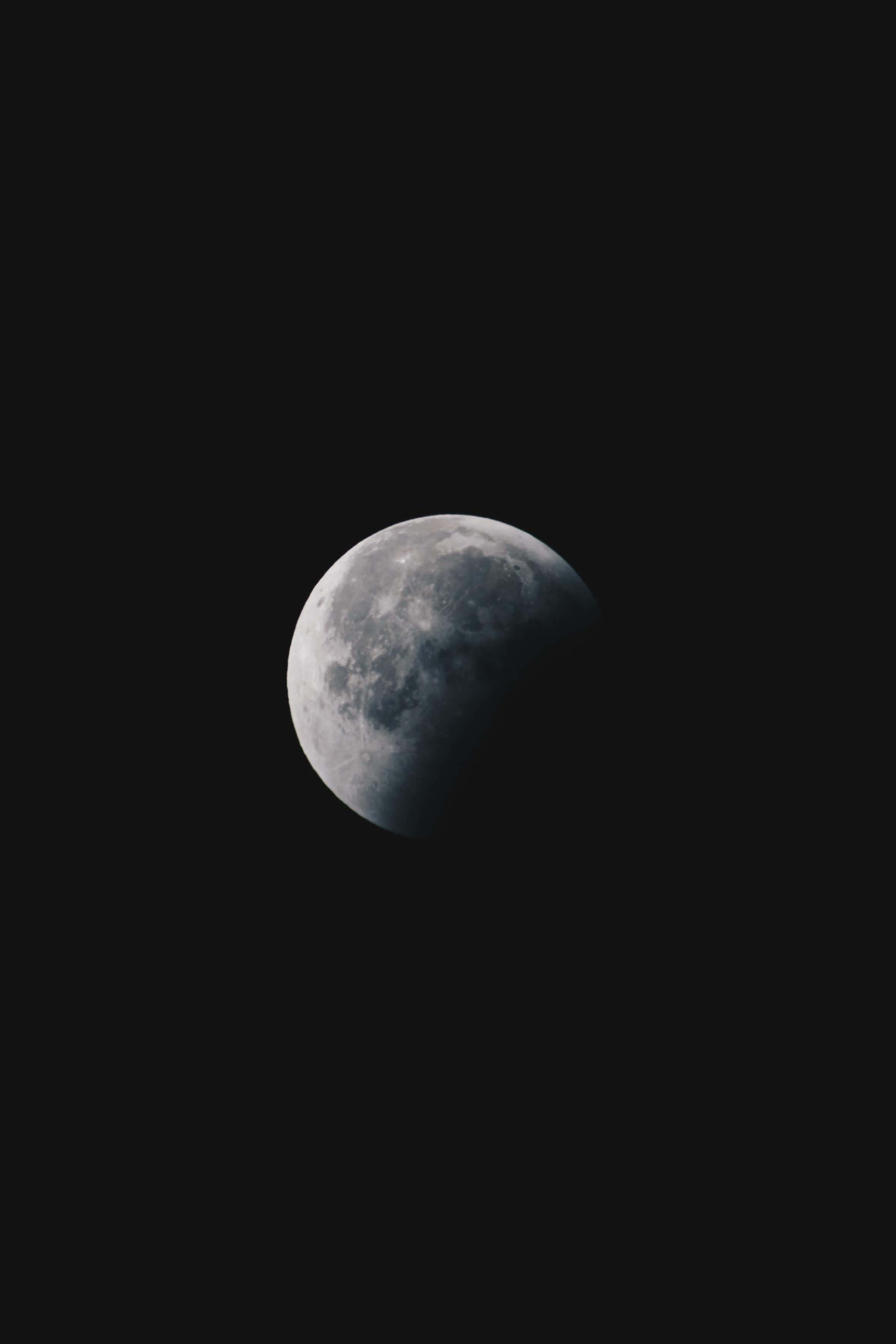 a moon is seen in the dark sky — 2361x3541 wallpaper