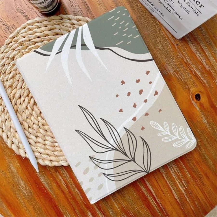 a notebook with a leaf design on it — 900x900 wallpaper