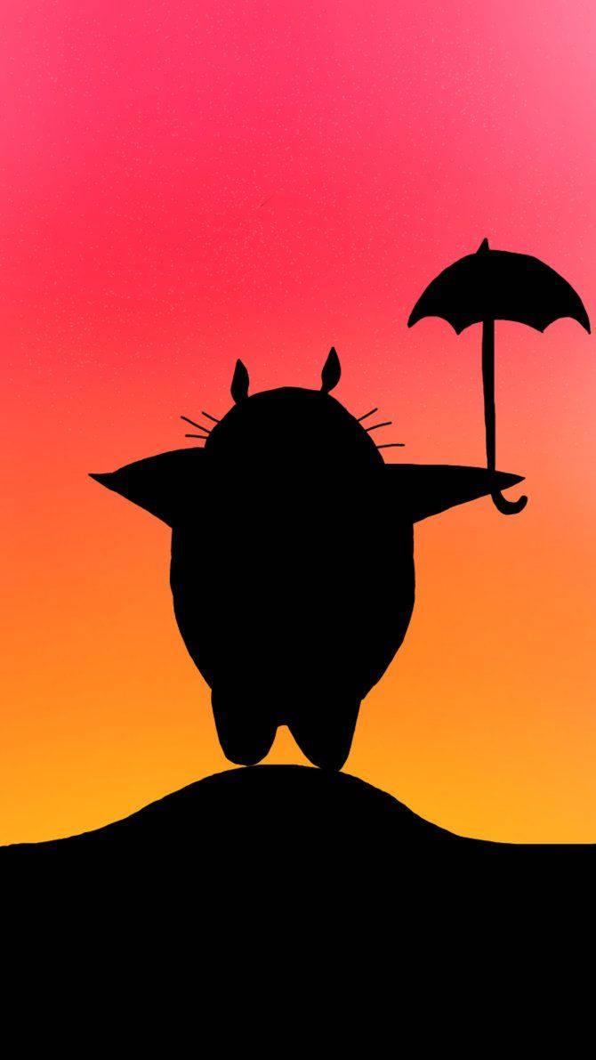 A silhouette of the beloved character Totoro against a backdrop of a beautiful sunset. — 670x1191 wallpaper