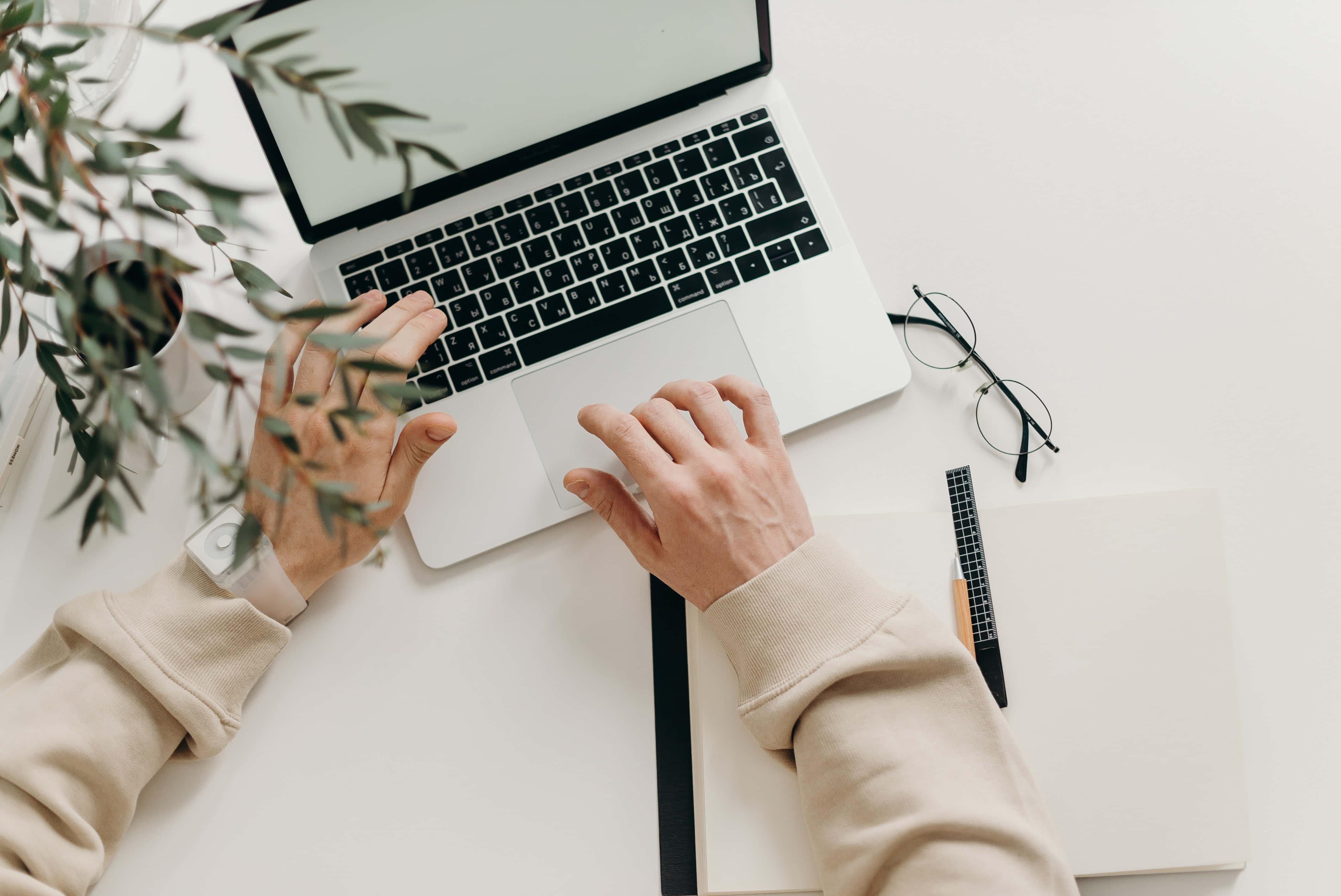 A sleek laptop perched atop a wooden desk — 4240x2832 wallpaper