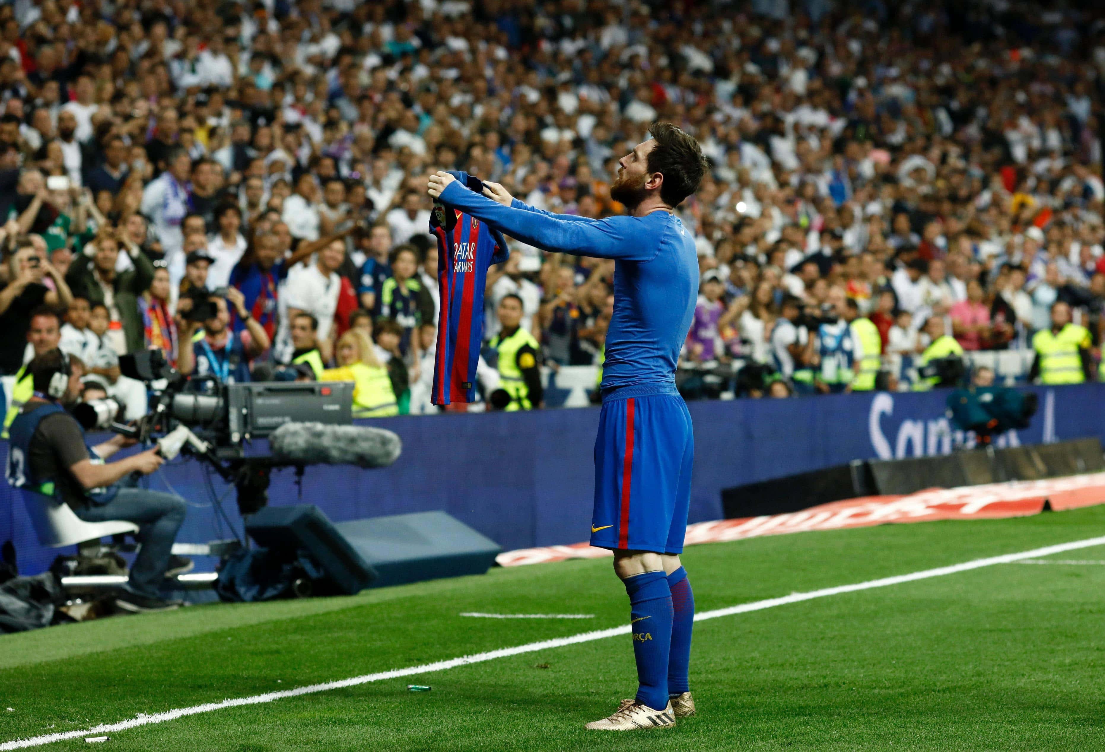 a soccer player is holding up a scarf — 3725x2534 wallpaper