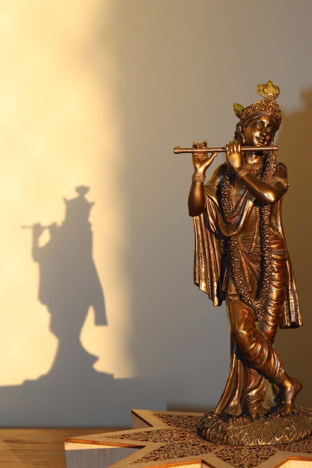 a statue of a flute player is on a table