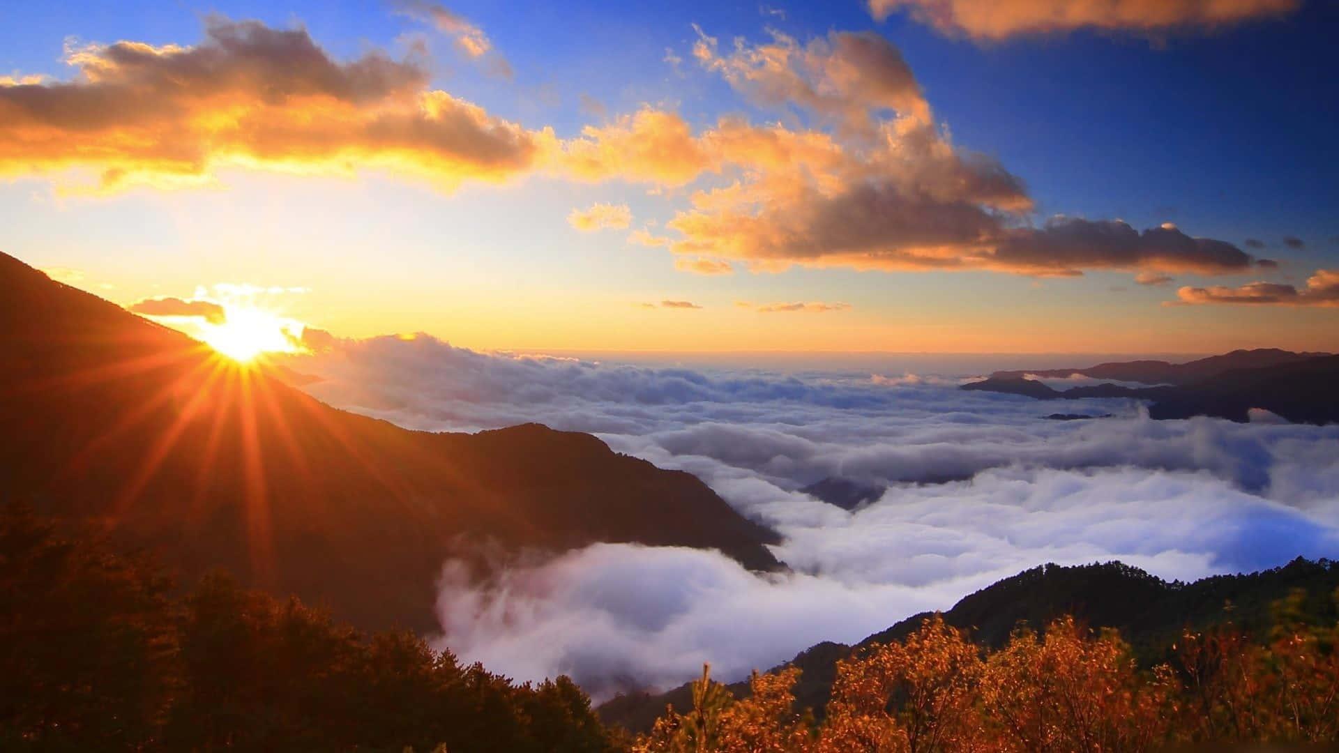 a sunrise over clouds in the mountains — 1920x1080 wallpaper