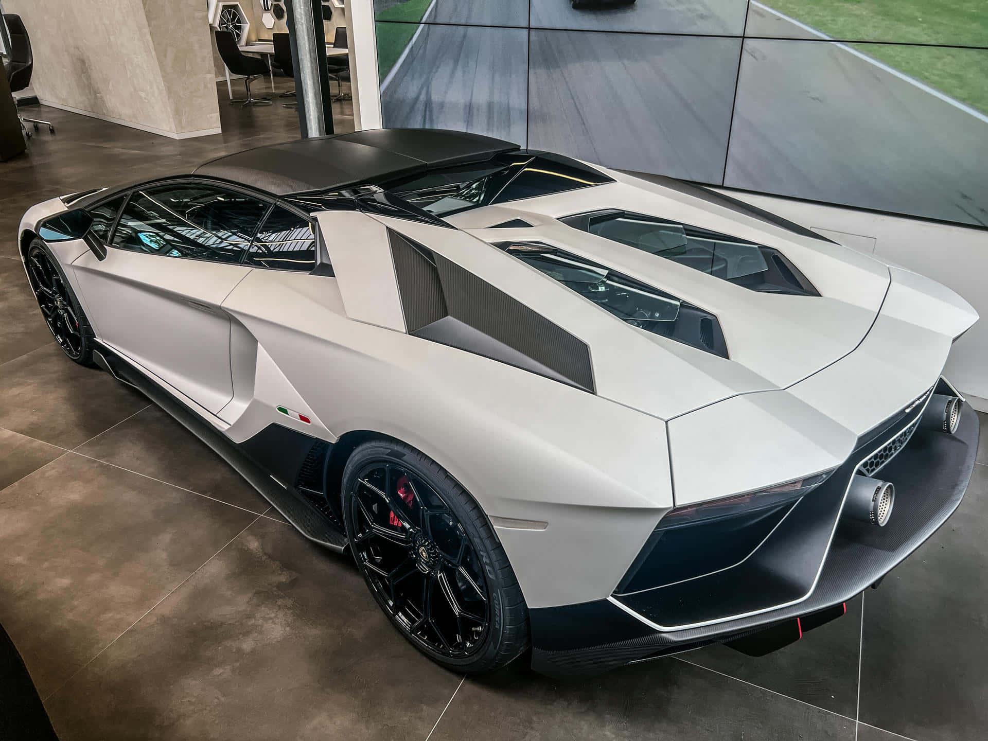 a white and black lamborghini huracan is parked in a showroom — 1920x1440 wallpaper