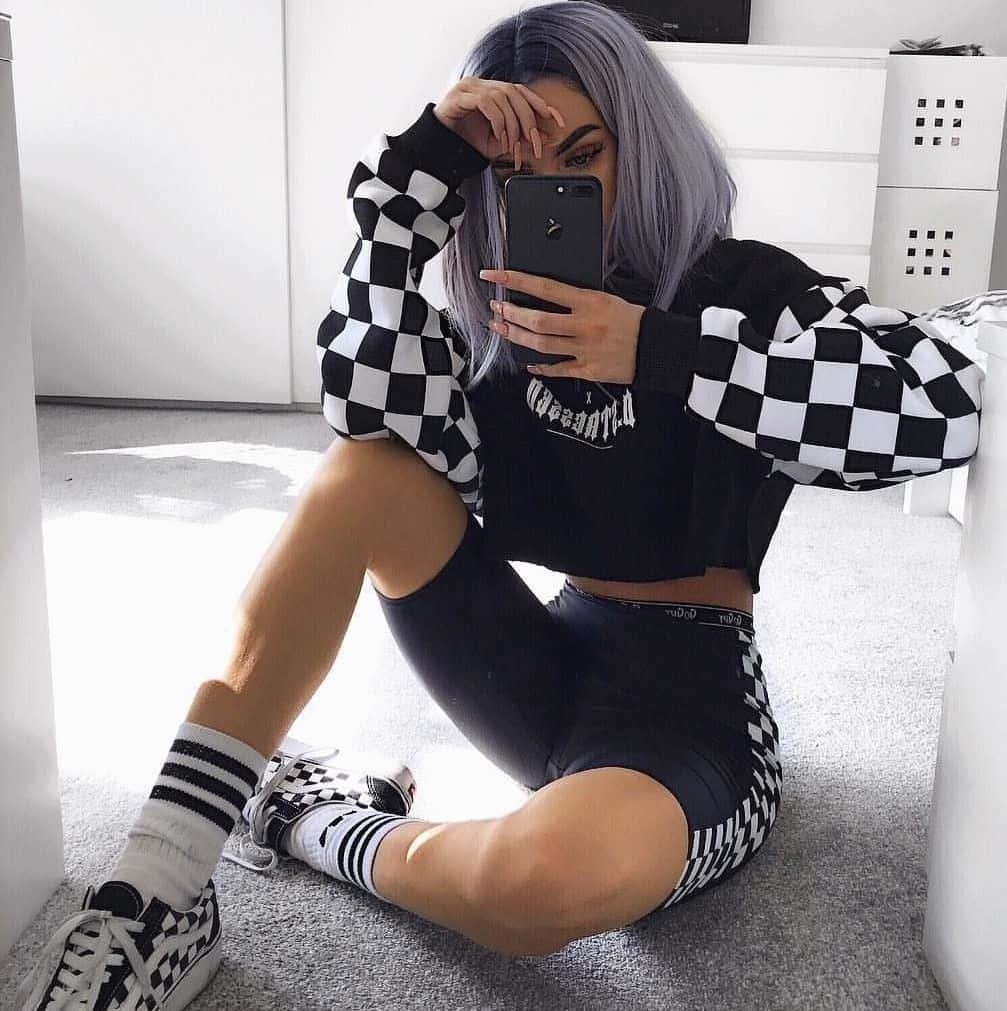 a woman wearing a checkered sweatshirt and sneakers — 1007x1011 wallpaper