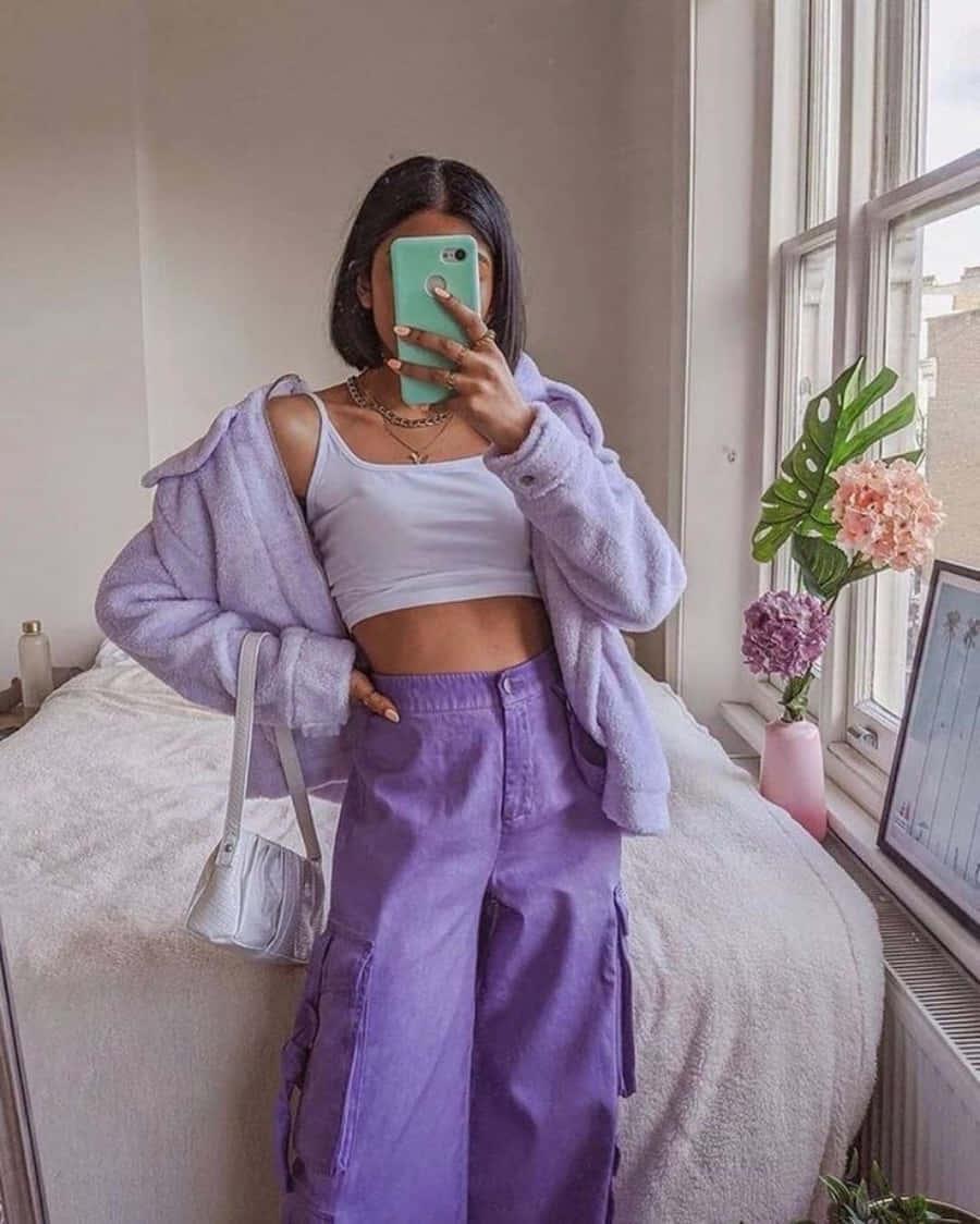 a woman wearing purple pants and a white top — 900x1124 wallpaper