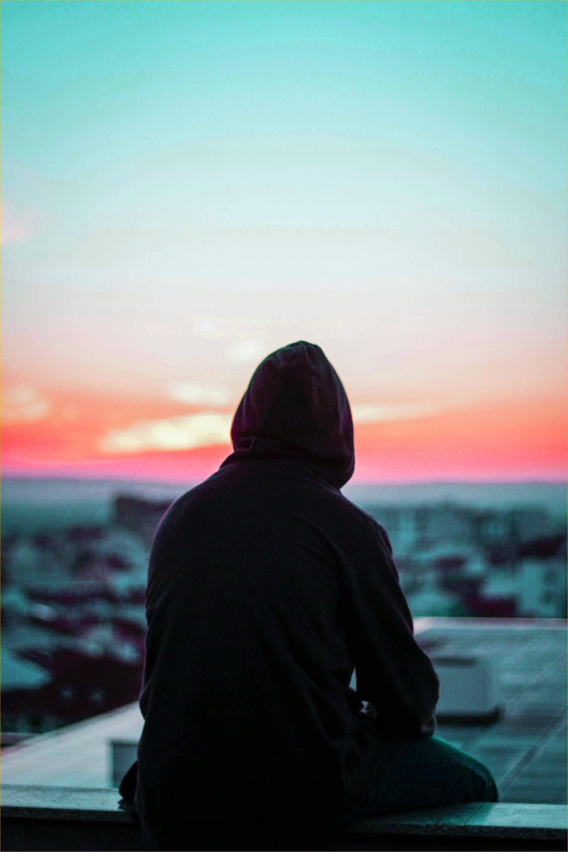 A young man dealing with heartbreak, depicted in a poignant, atmospheric setting. — 2304x3456 wallpaper