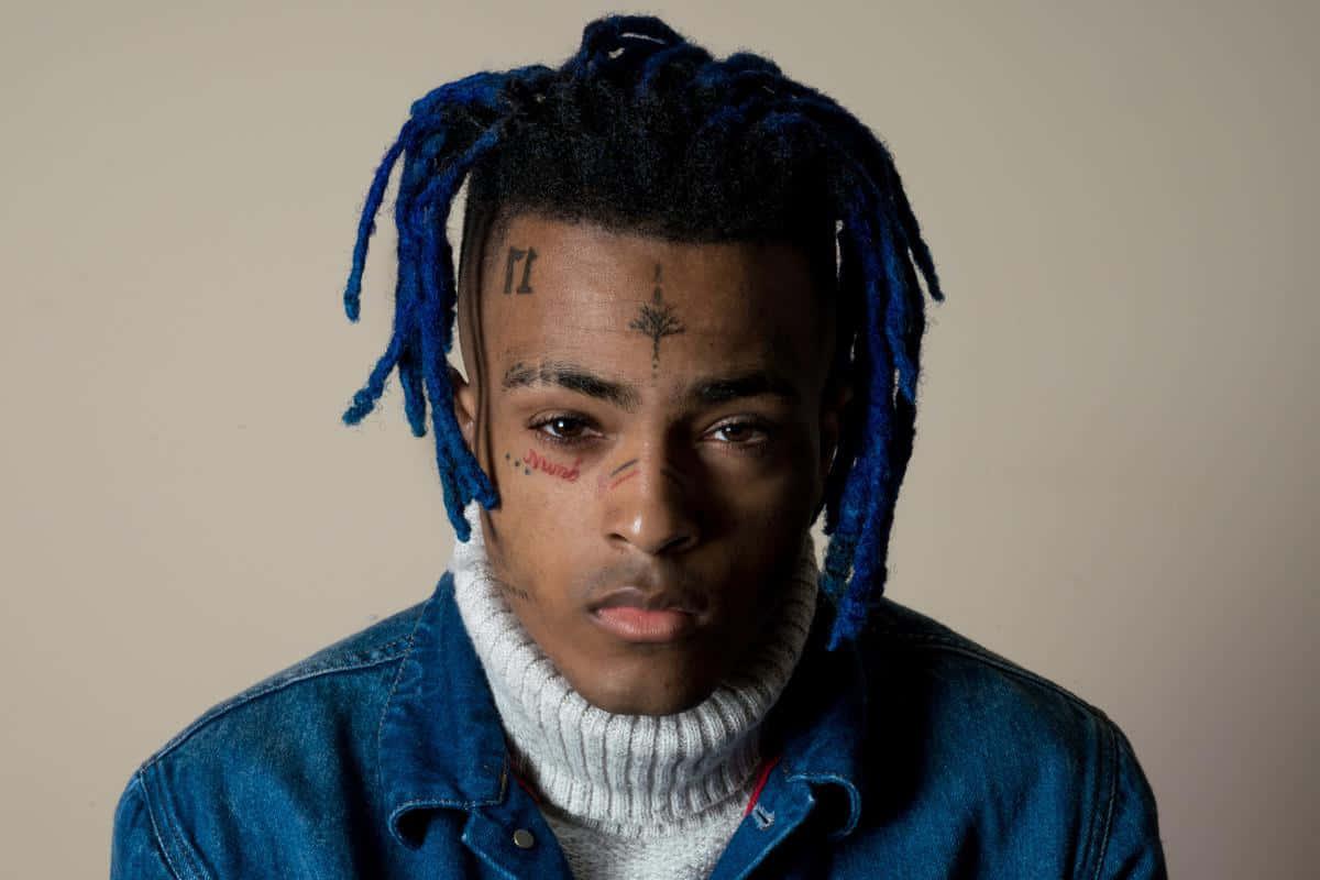 a young man with blue dreadlocks and a blue jacket — 1200x800 wallpaper