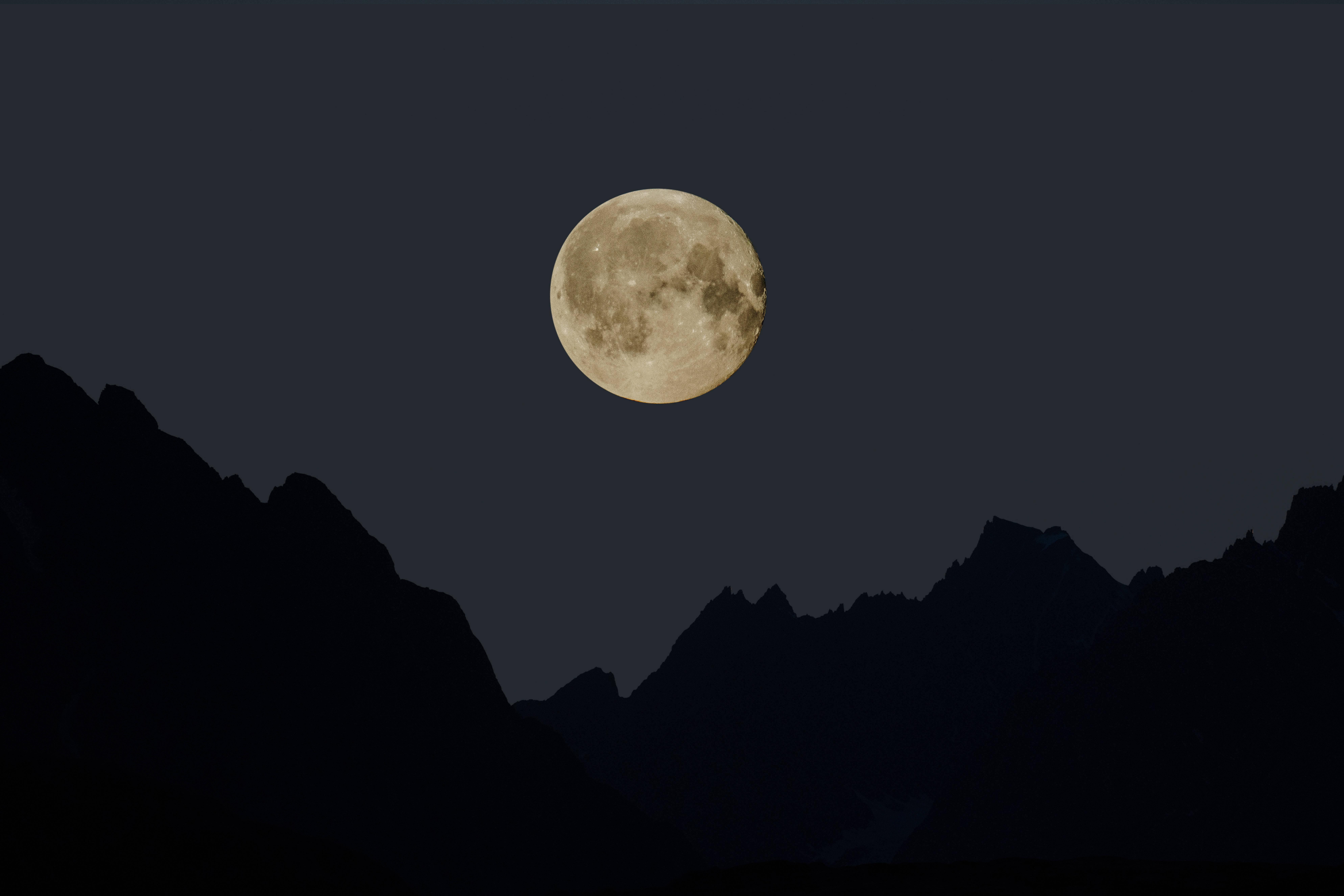 Aesthetic silhouette of a full moon on a crisp night sky — 7952x5304 wallpaper