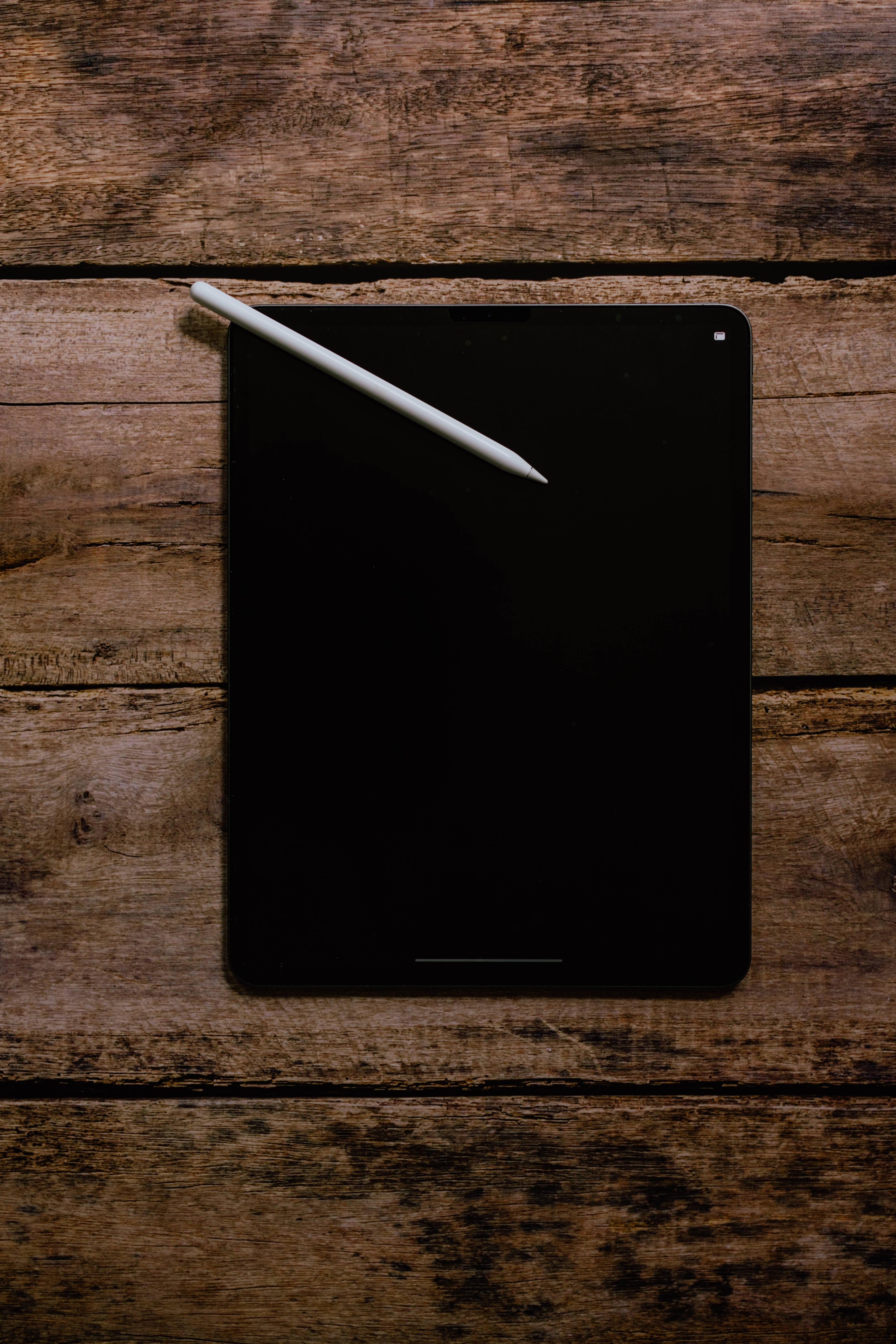 Apple iPad Pro On Wood — 3653x5480 wallpaper