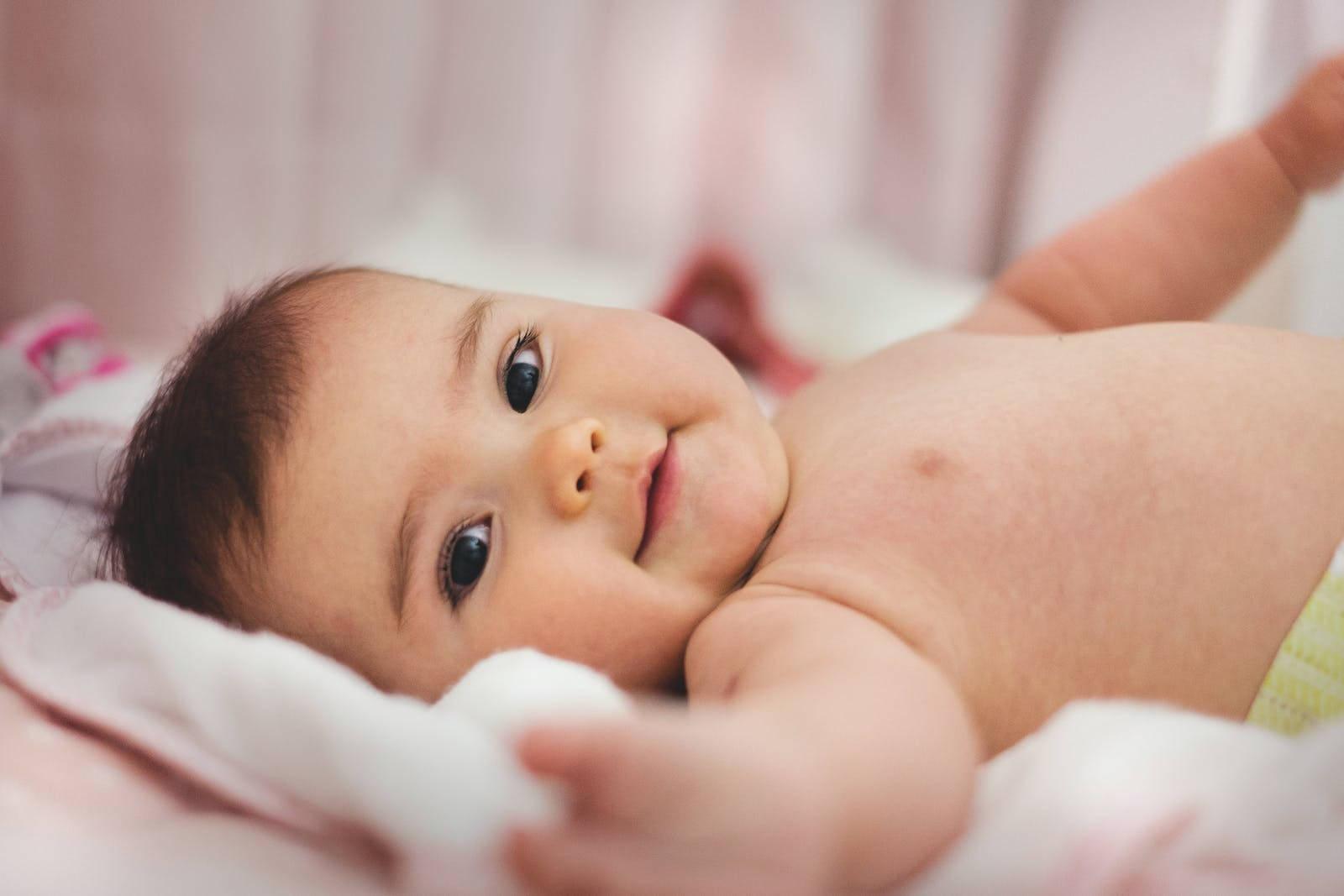 Baby Boy Laying On Bed — 1600x1067 wallpaper