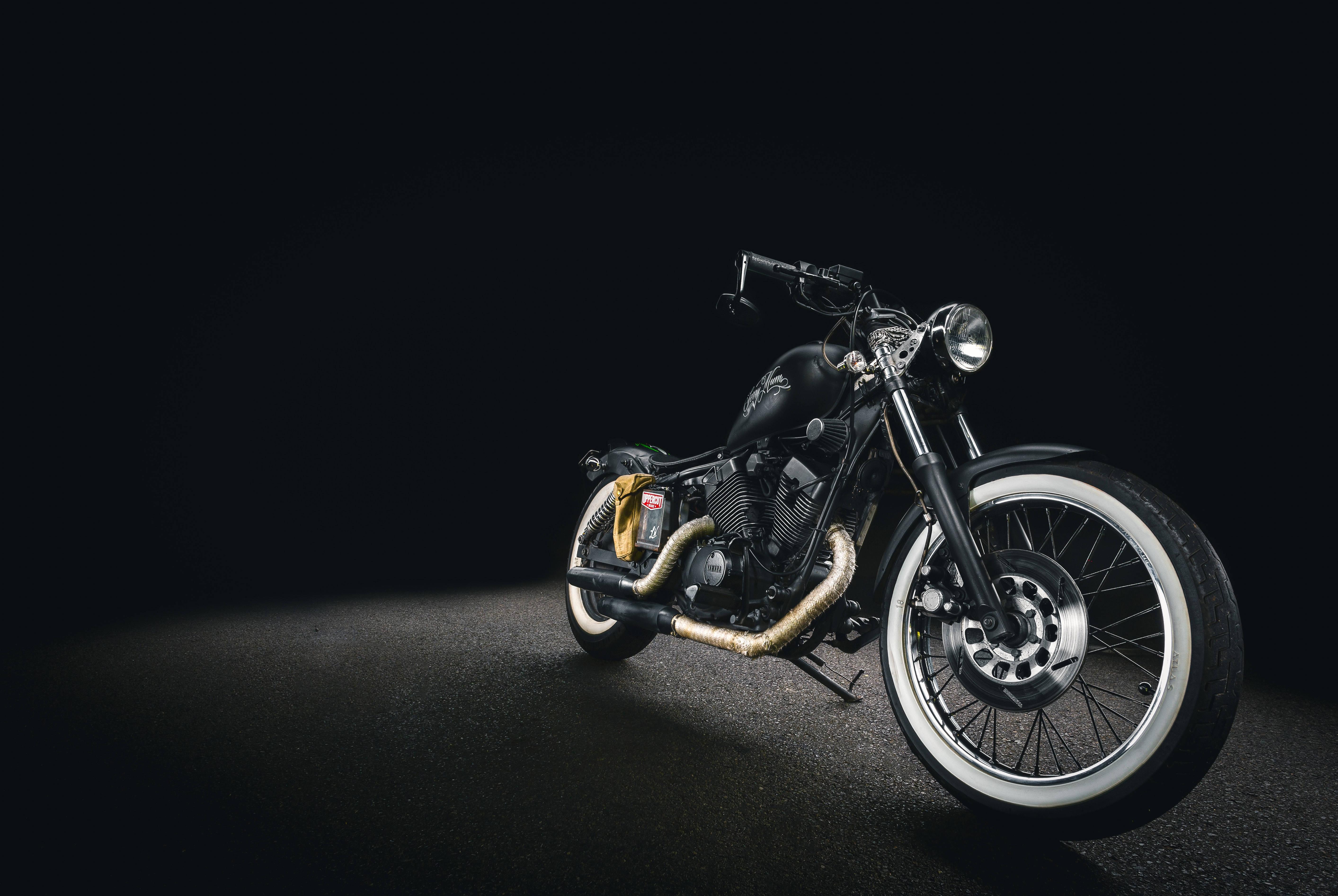 A vintage black motorcycle showcasing antiquity and elegance — 5653x3788 wallpaper