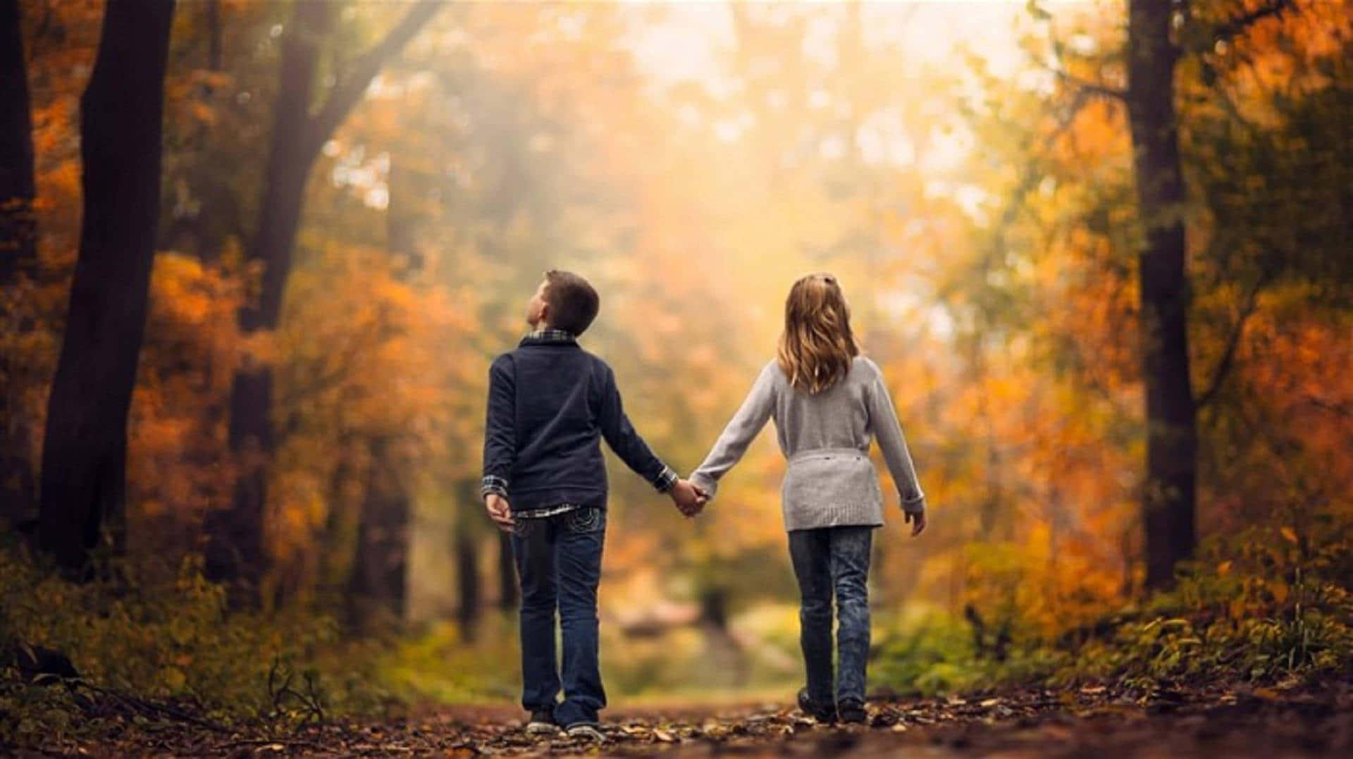 couple holding hands in the autumn forest — 1920x1077 wallpaper