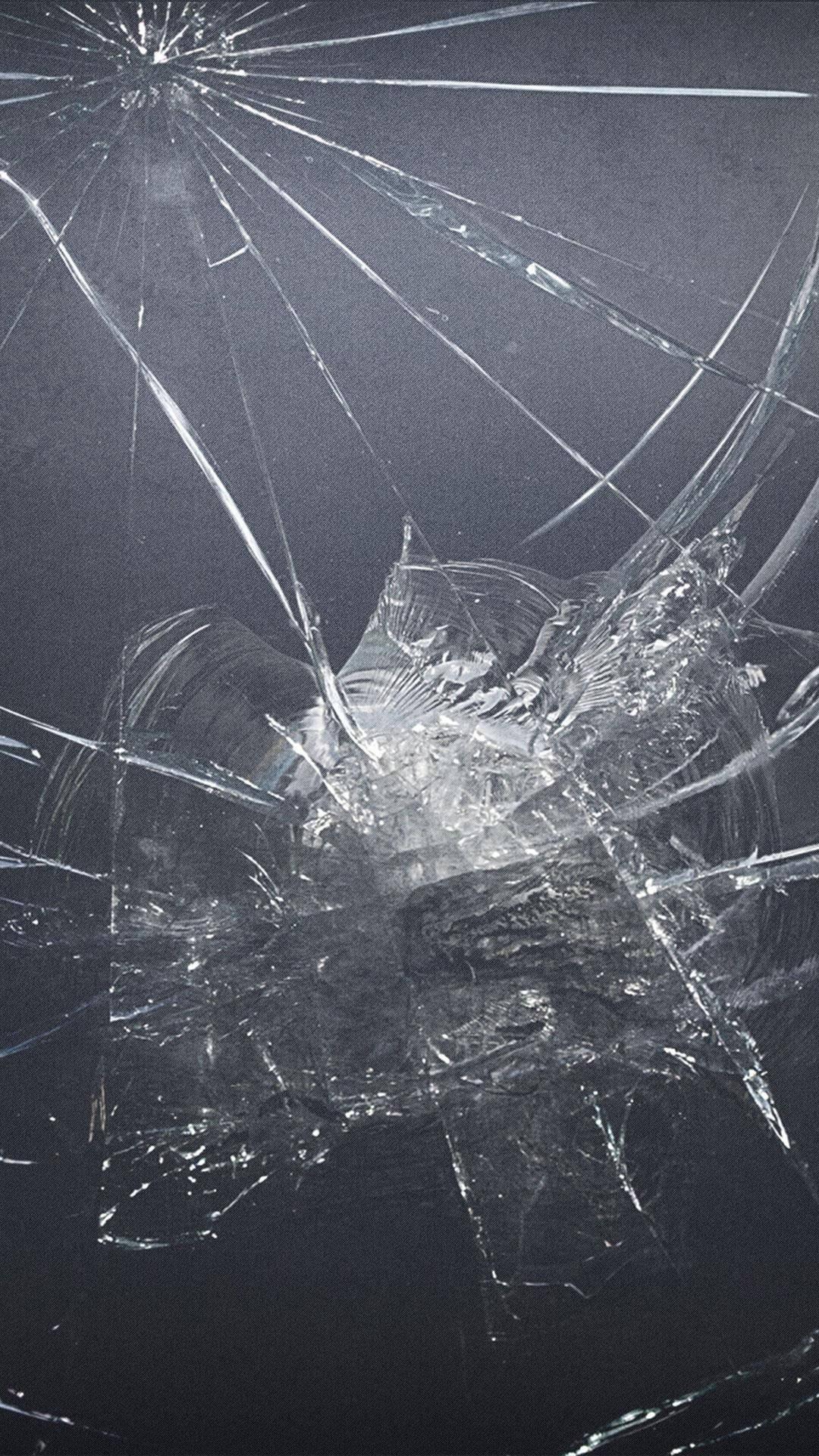 Cracked Screen On Gray Surface — 1080x1920 wallpaper