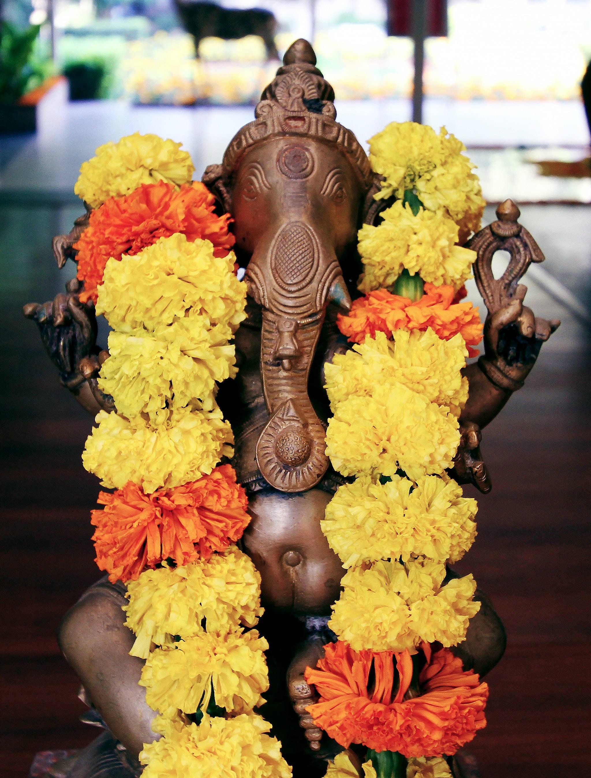 Divine Ganesha with Marigold Garland on Mobile — 2048x2696 wallpaper