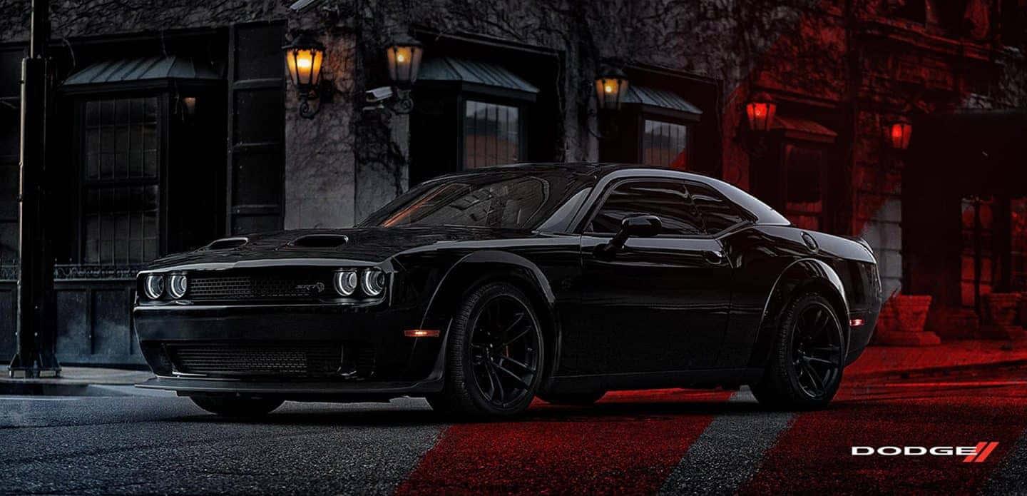 dodge challenger srt - a black car parked on a street — 1440x695 wallpaper