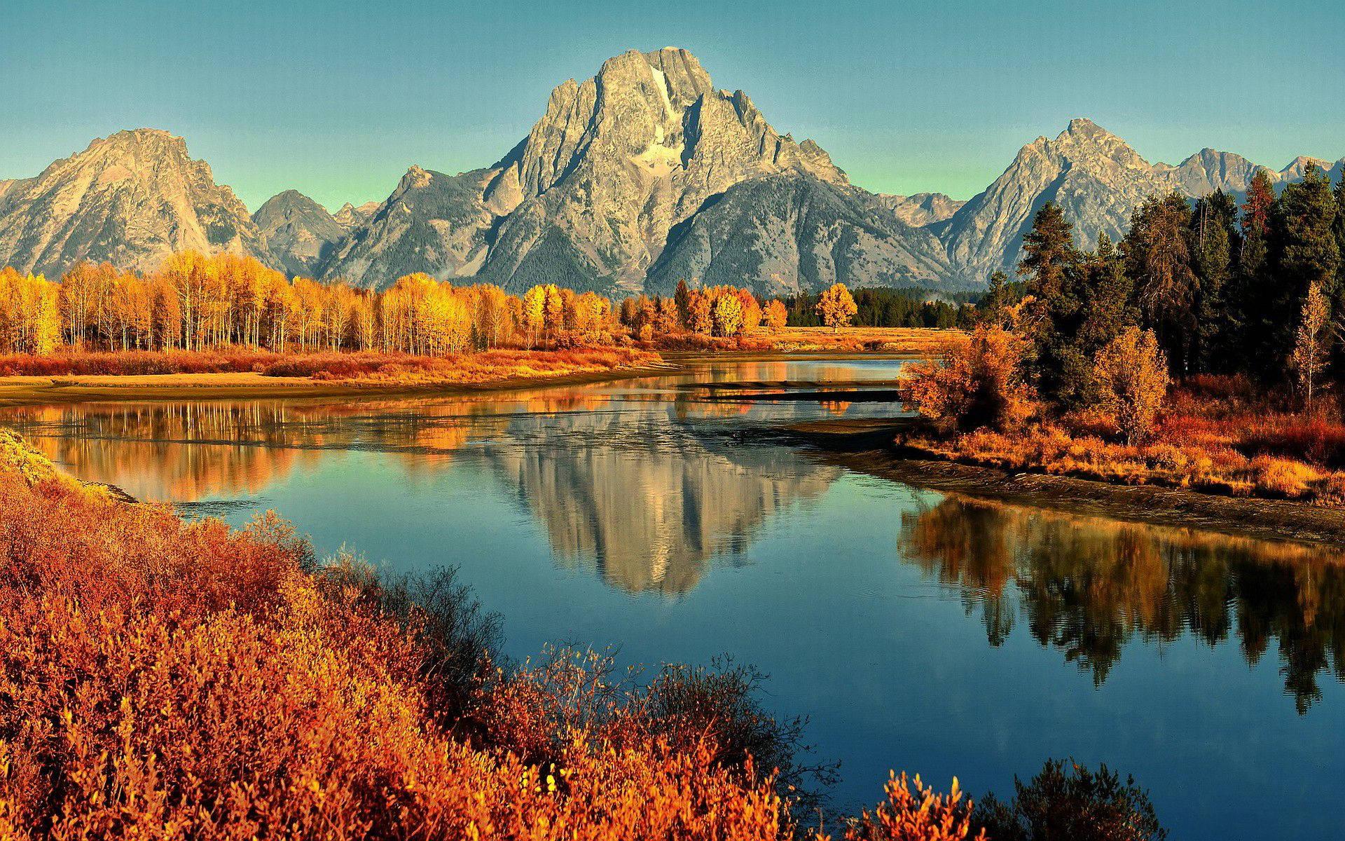Enjoy the picturesque autumn landscape of a lake surrounded by mountain. — 1920x1200 wallpaper