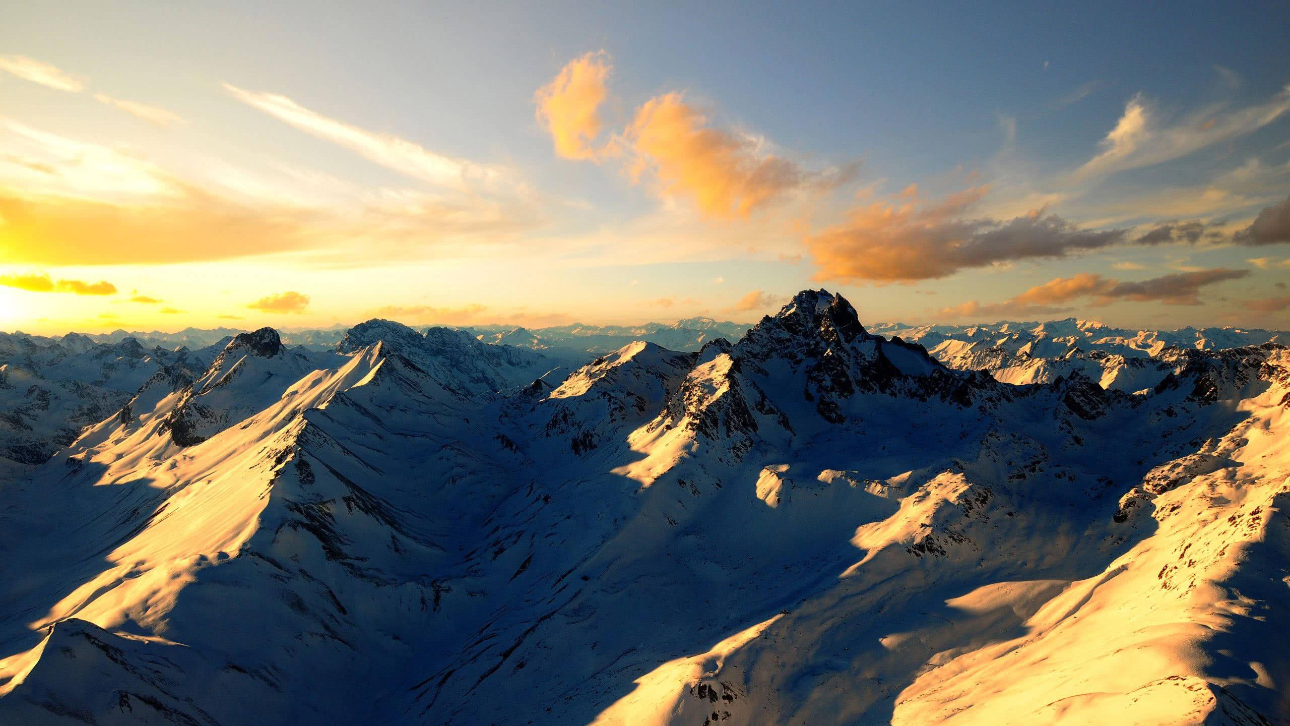 Enjoying the Beauty of Snowy Mountain Peaks — 2560x1440 wallpaper