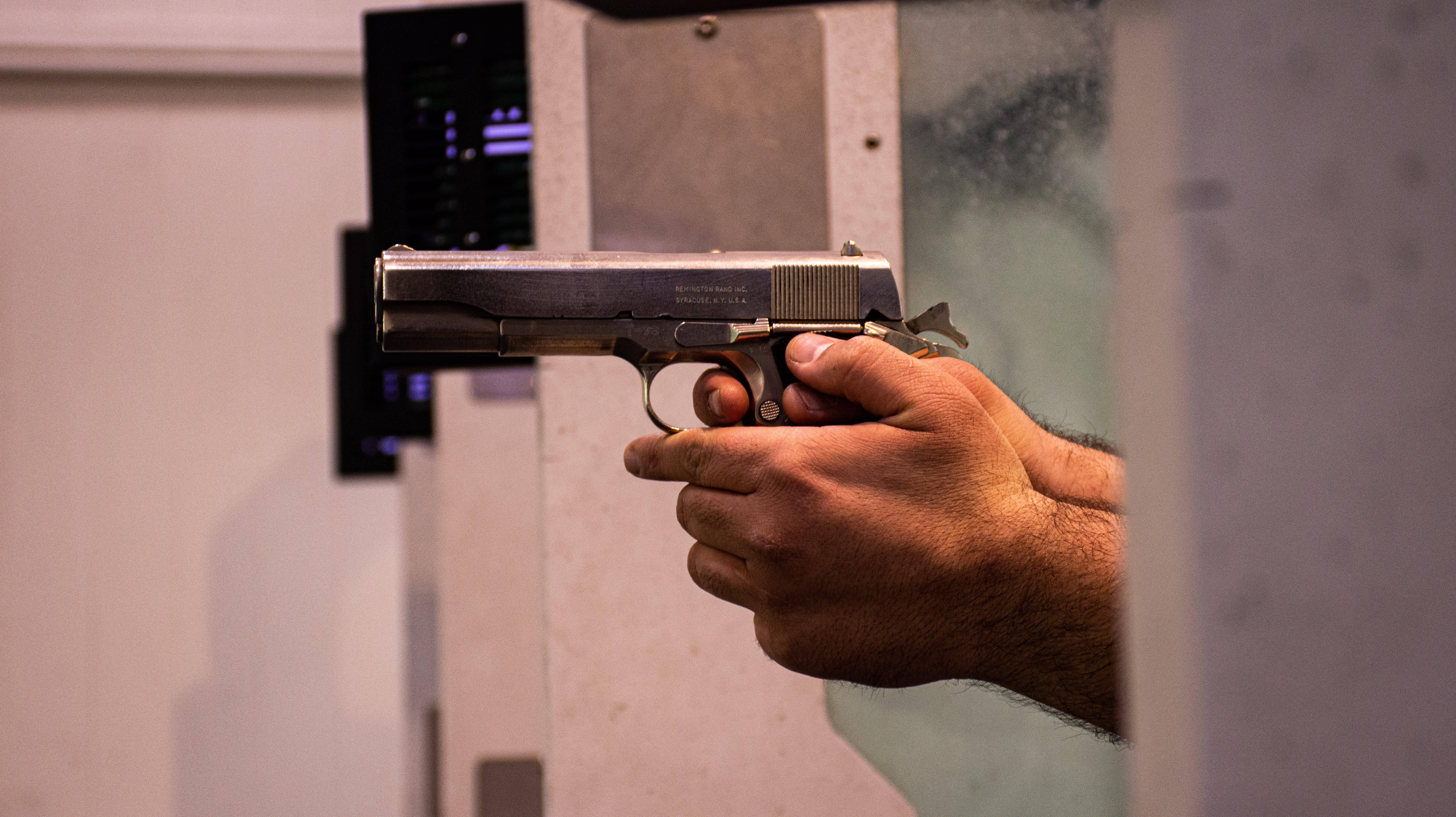 Hands Holding Gun — 6000x3368 wallpaper
