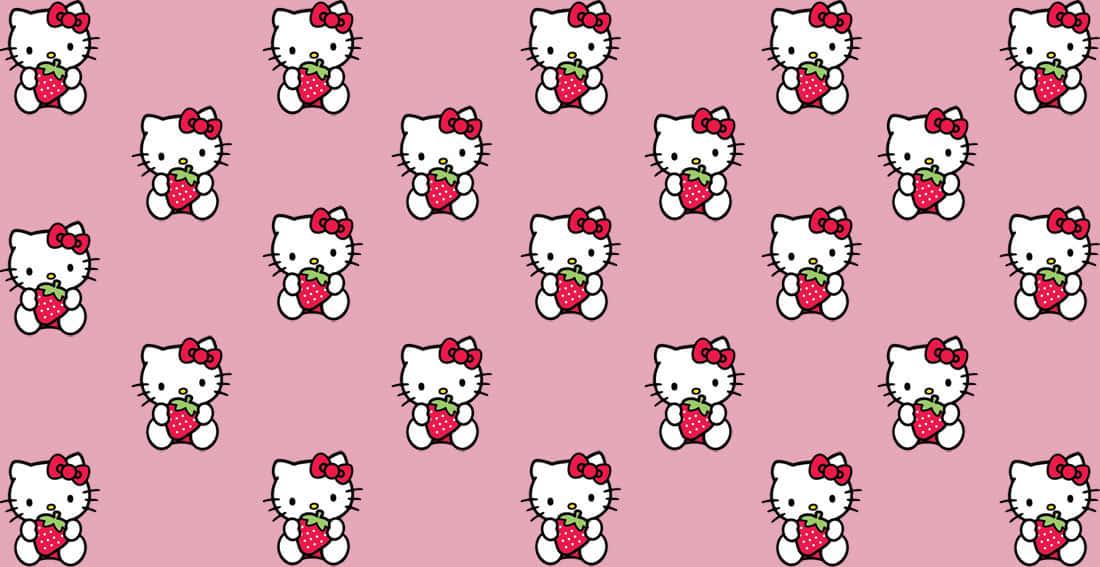 Hello Kitty greets fans from a pink and white computer screen. — 1100x567 wallpaper