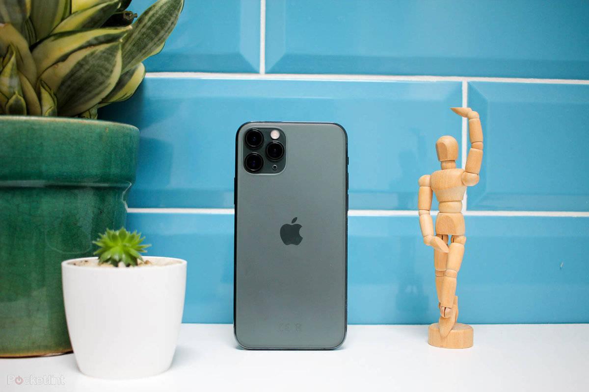 iPhone 11 Pro And Wooden Statue — 1200x800 wallpaper