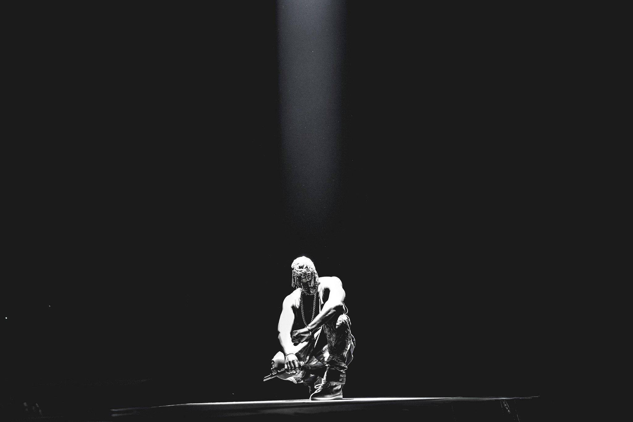 Kanye West Kneeling Under Light — 2048x1365 wallpaper