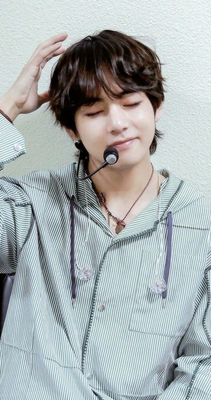 Kim Taehyung of BTS radiates with genuine optimism. — 675x1280 wallpaper