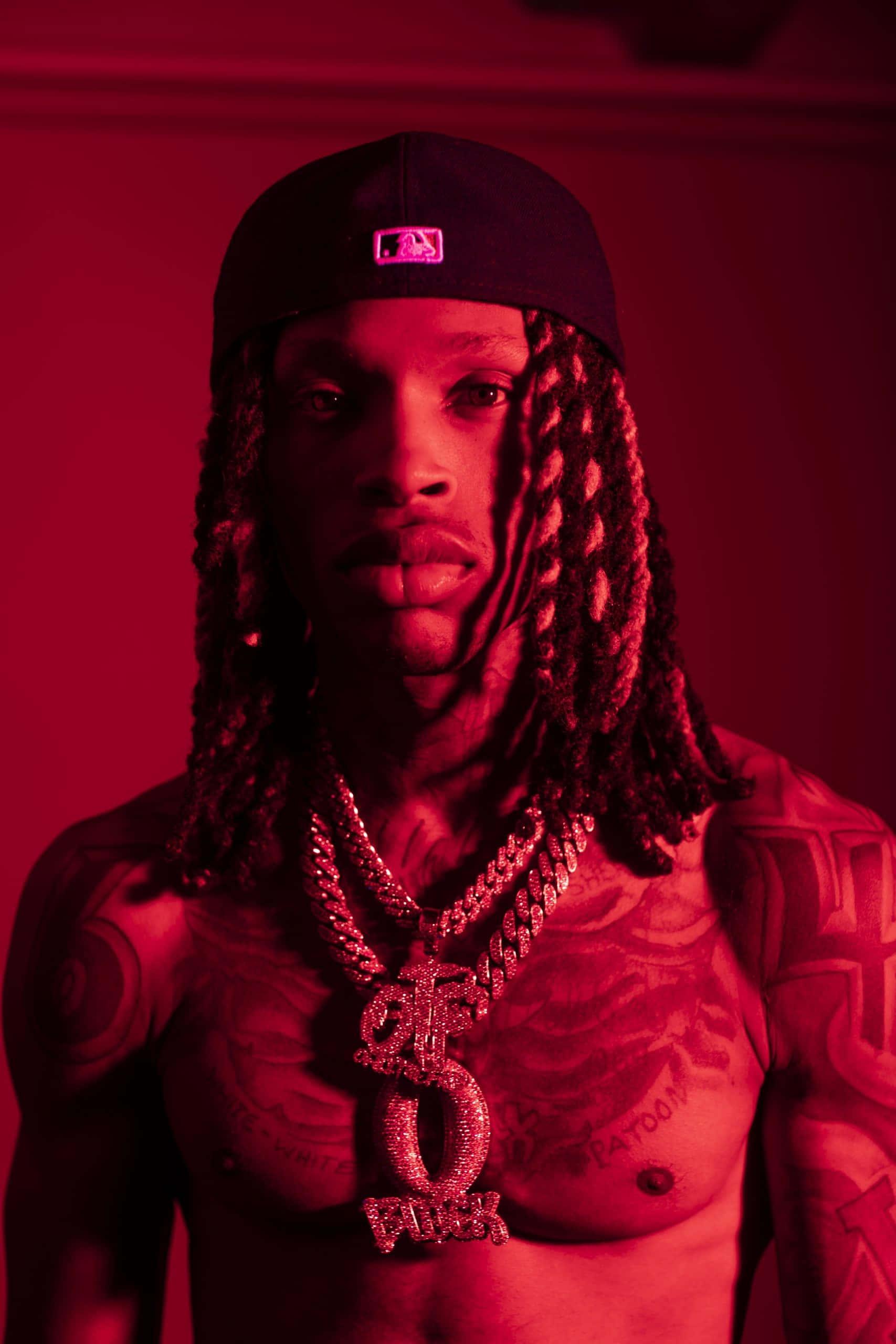 King Von displaying his charismatic presence in a street-style photoshoot. — 1707x2560 wallpaper