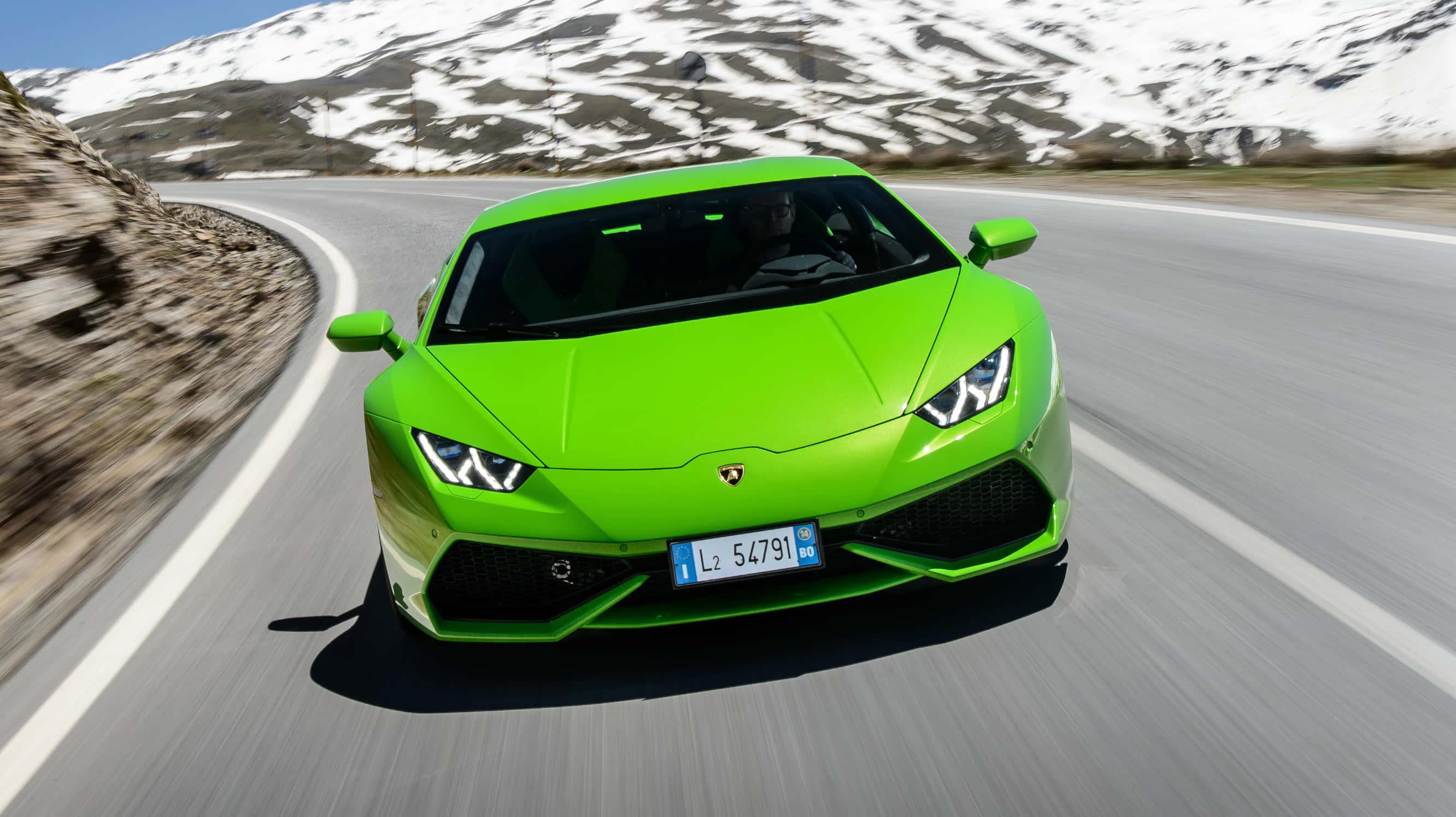 lamborghini huracan - a green sports car driving down a mountain road — 2664x1496 wallpaper