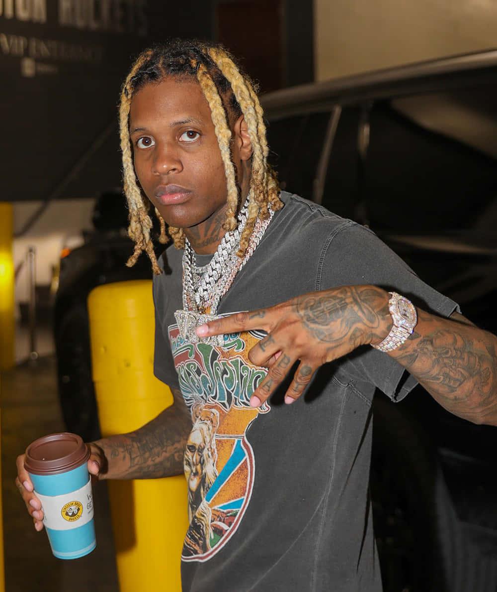 Lil Durk poses in a stylish outfit against a vibrant background — 1000x1189 wallpaper
