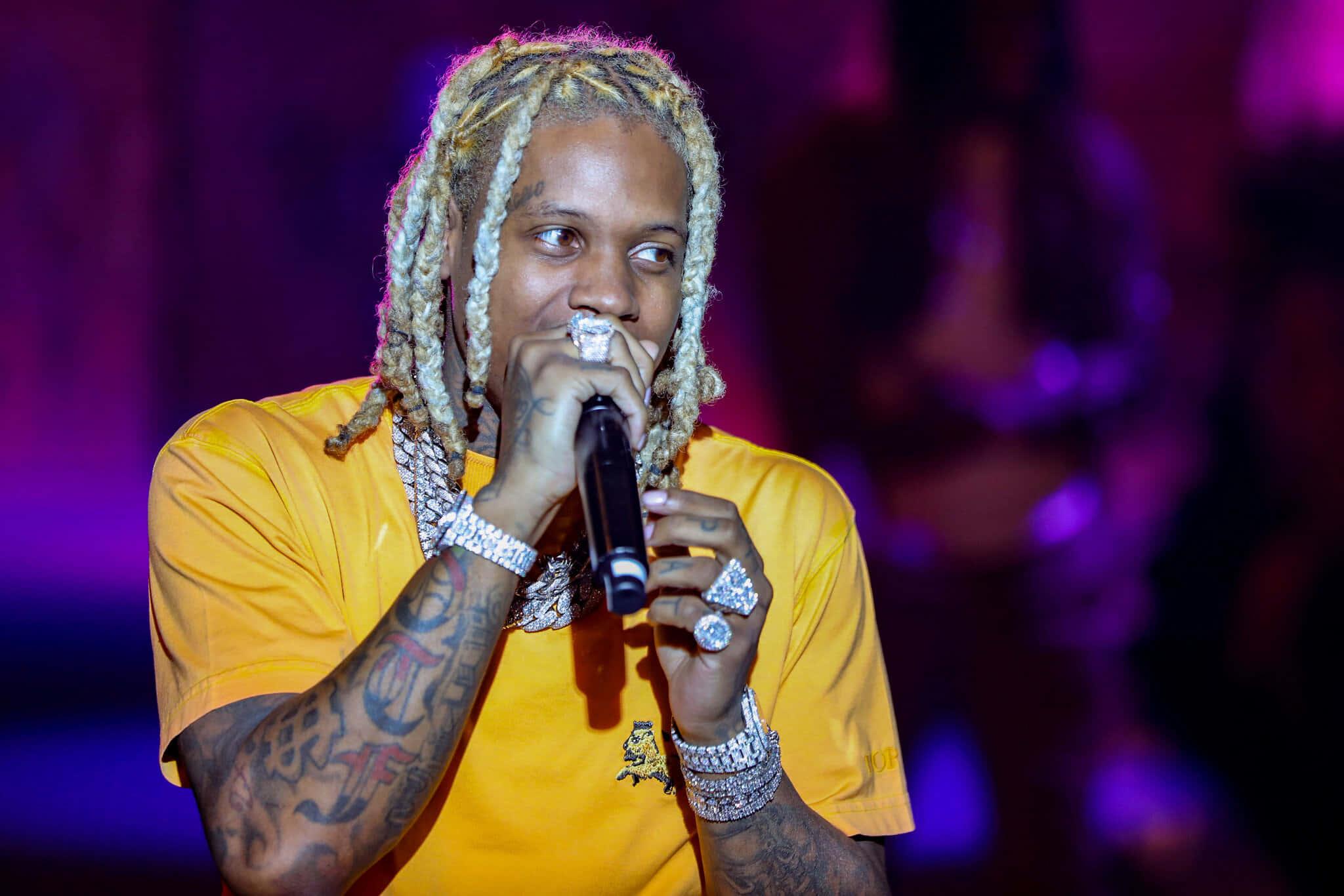 Lil Durk strikes a pose in front of graffiti backdrop — 2048x1366 wallpaper