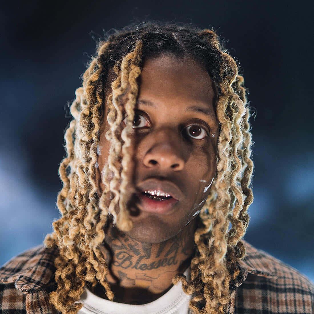 Lil Durk striking a pose in a stylish outfit. — 1100x1100 wallpaper