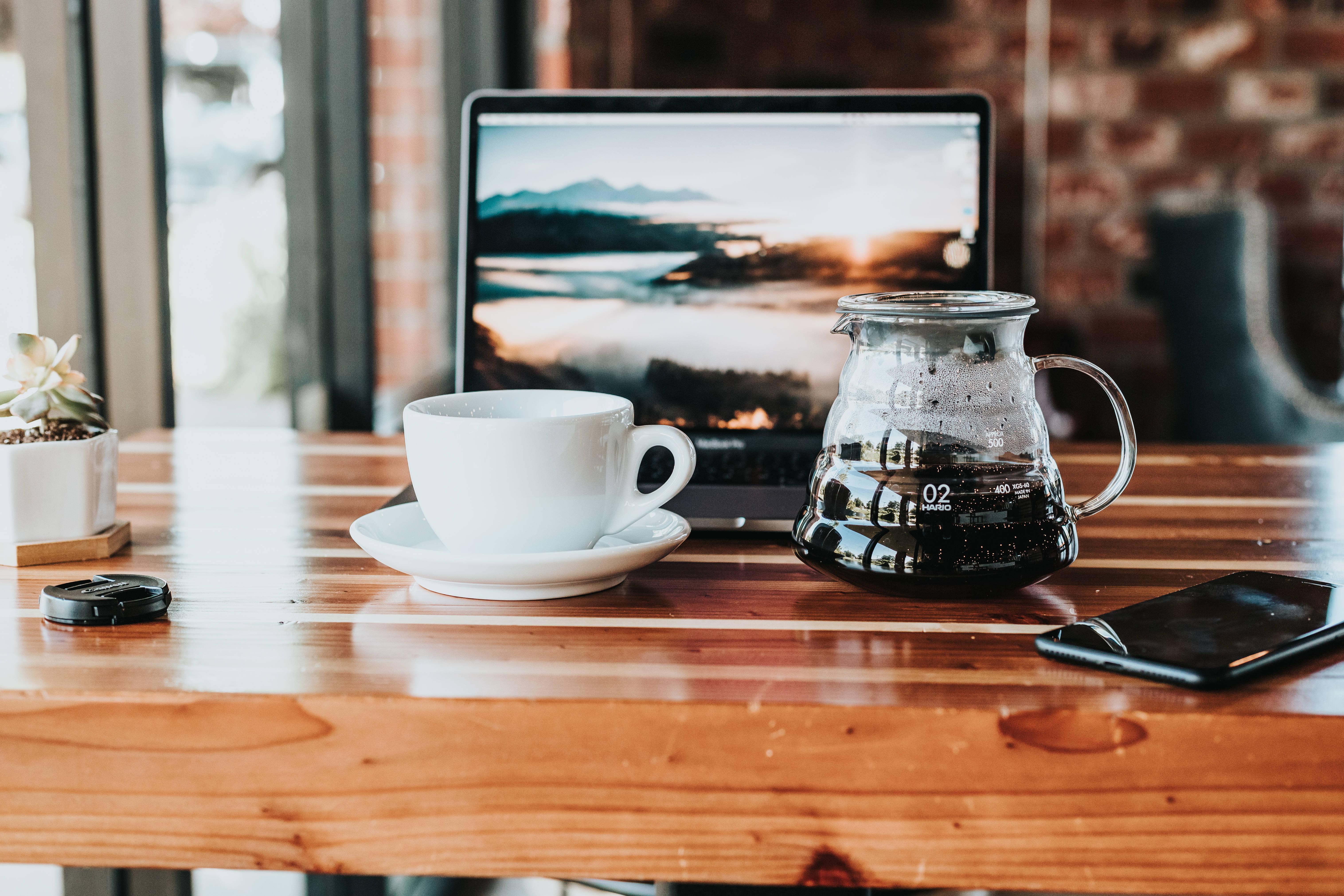 MacBook Pro On Wooden Countertop — 6064x4043 wallpaper