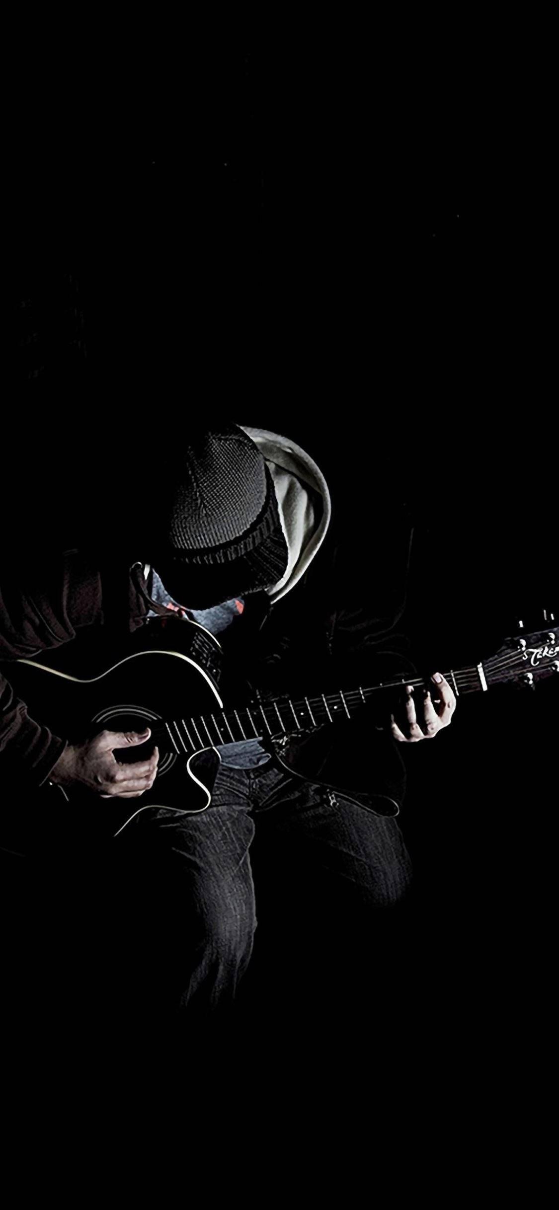 Man Playing Guitar iPhone Dark — 1125x2436 wallpaper