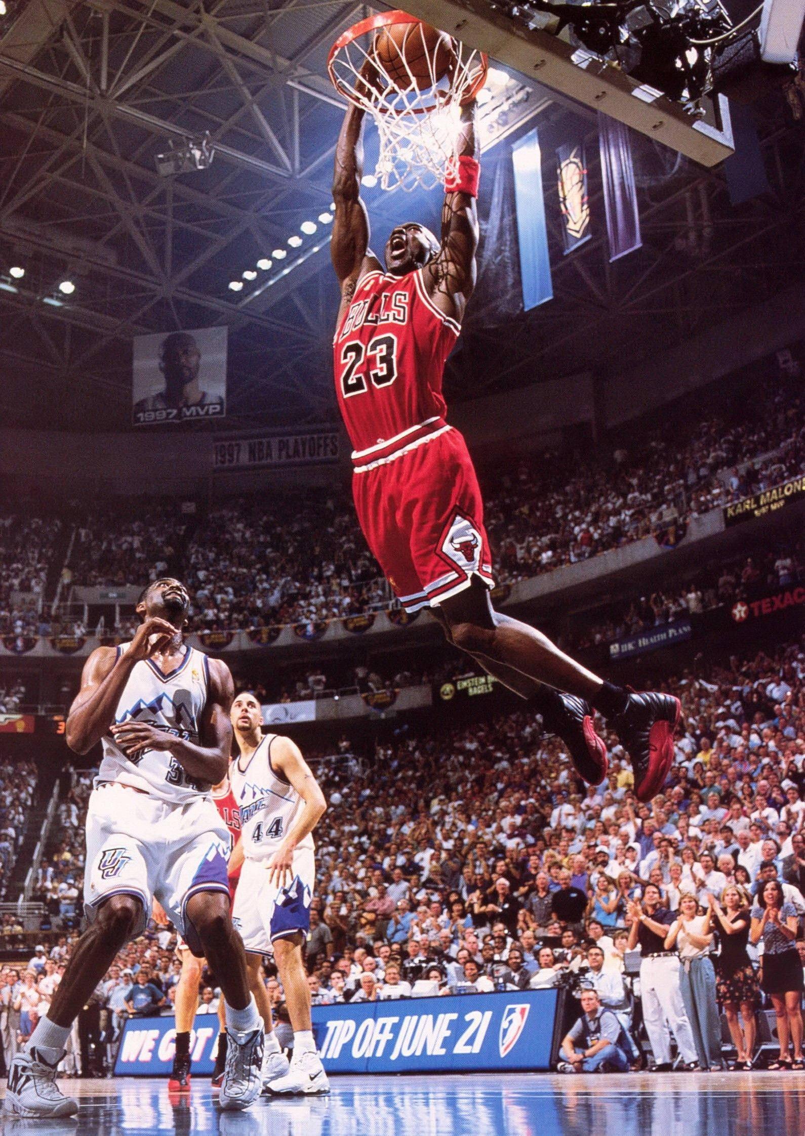 Michael Jordan flies through the air making a legendary dunk — 1590x2245 wallpaper