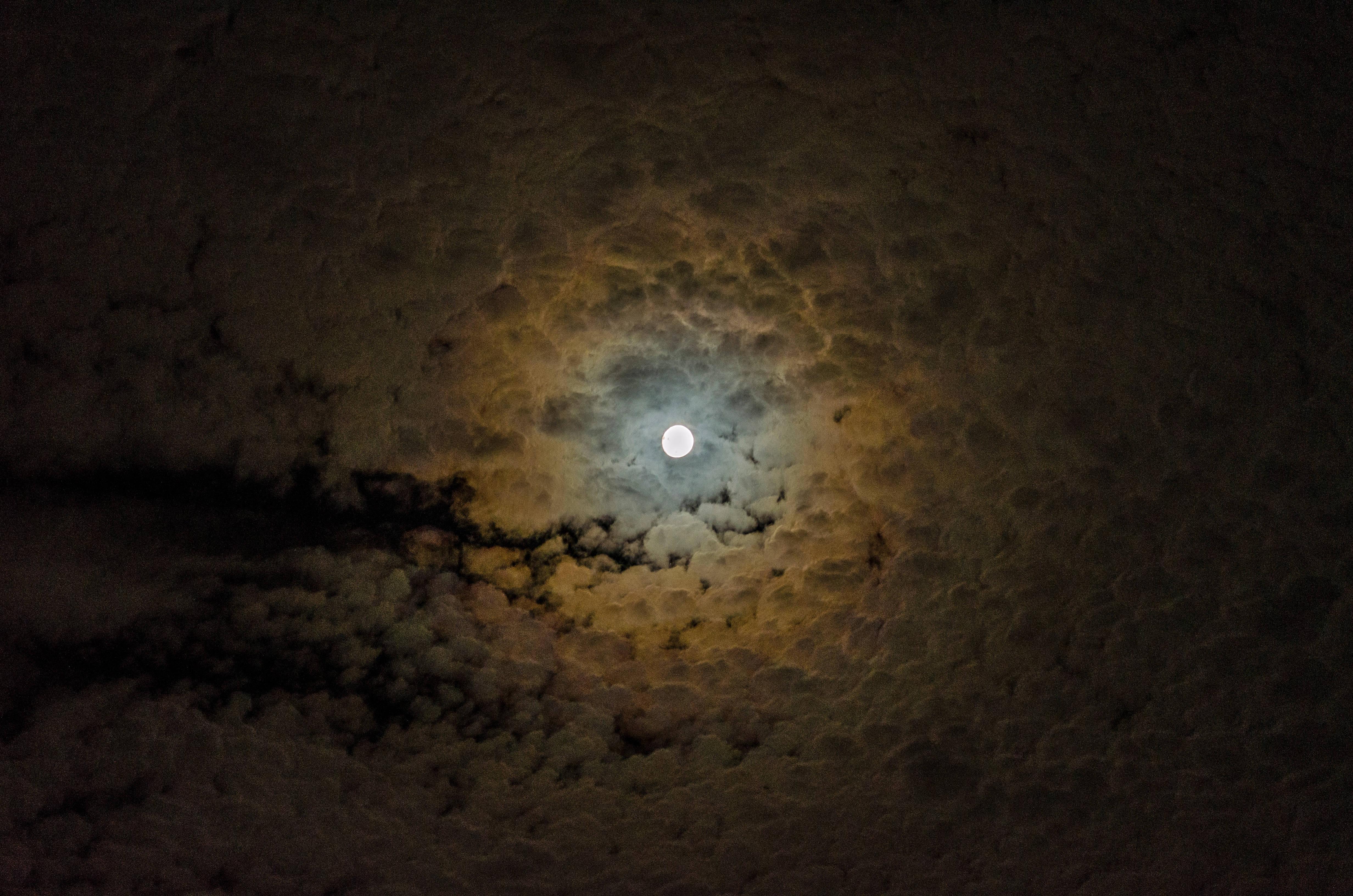 Moonlit clouds illuminated against the night sky — 4928x3264 wallpaper
