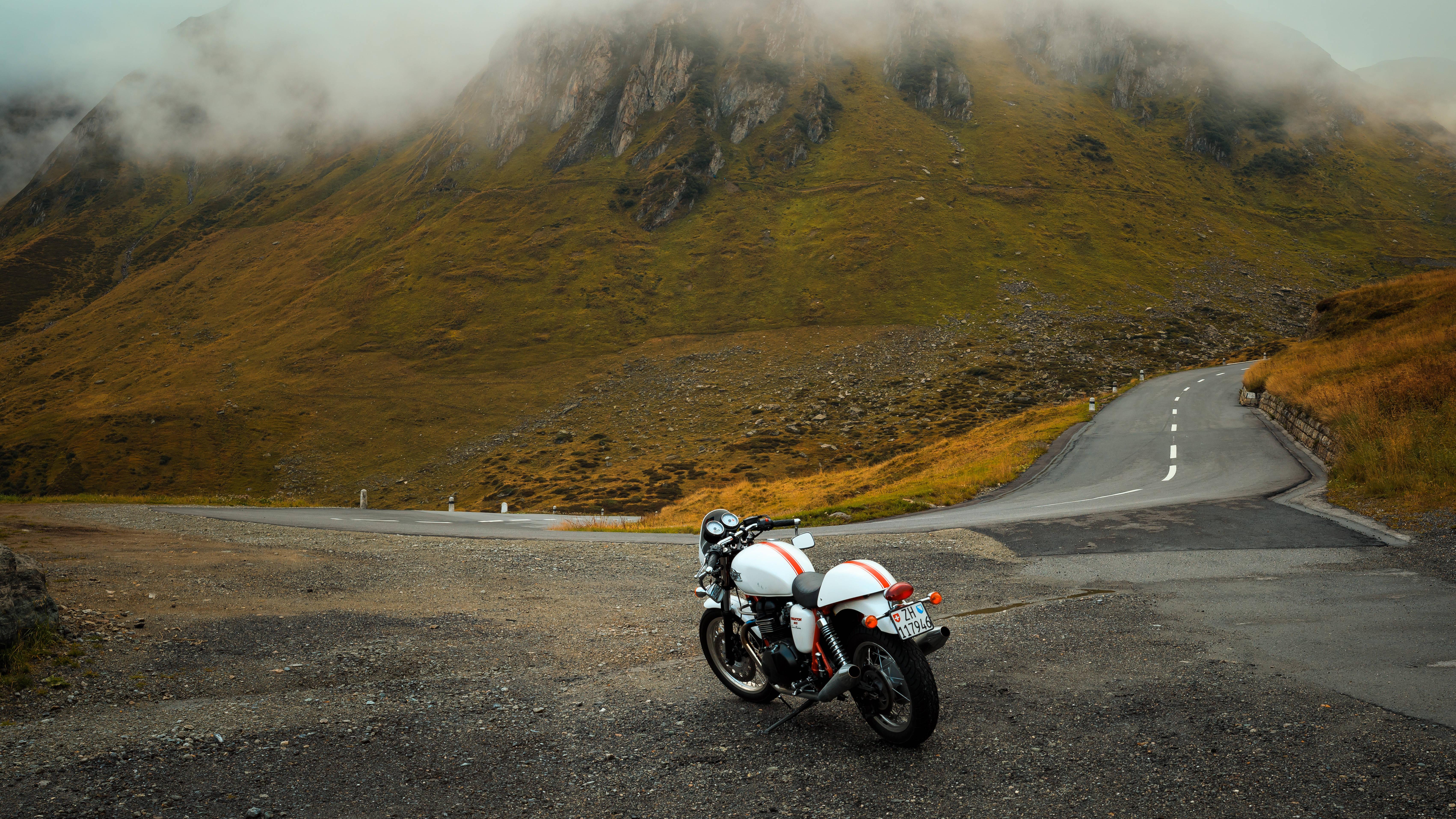 Motorcycle Parked Near Mountains — 6807x3829 wallpaper