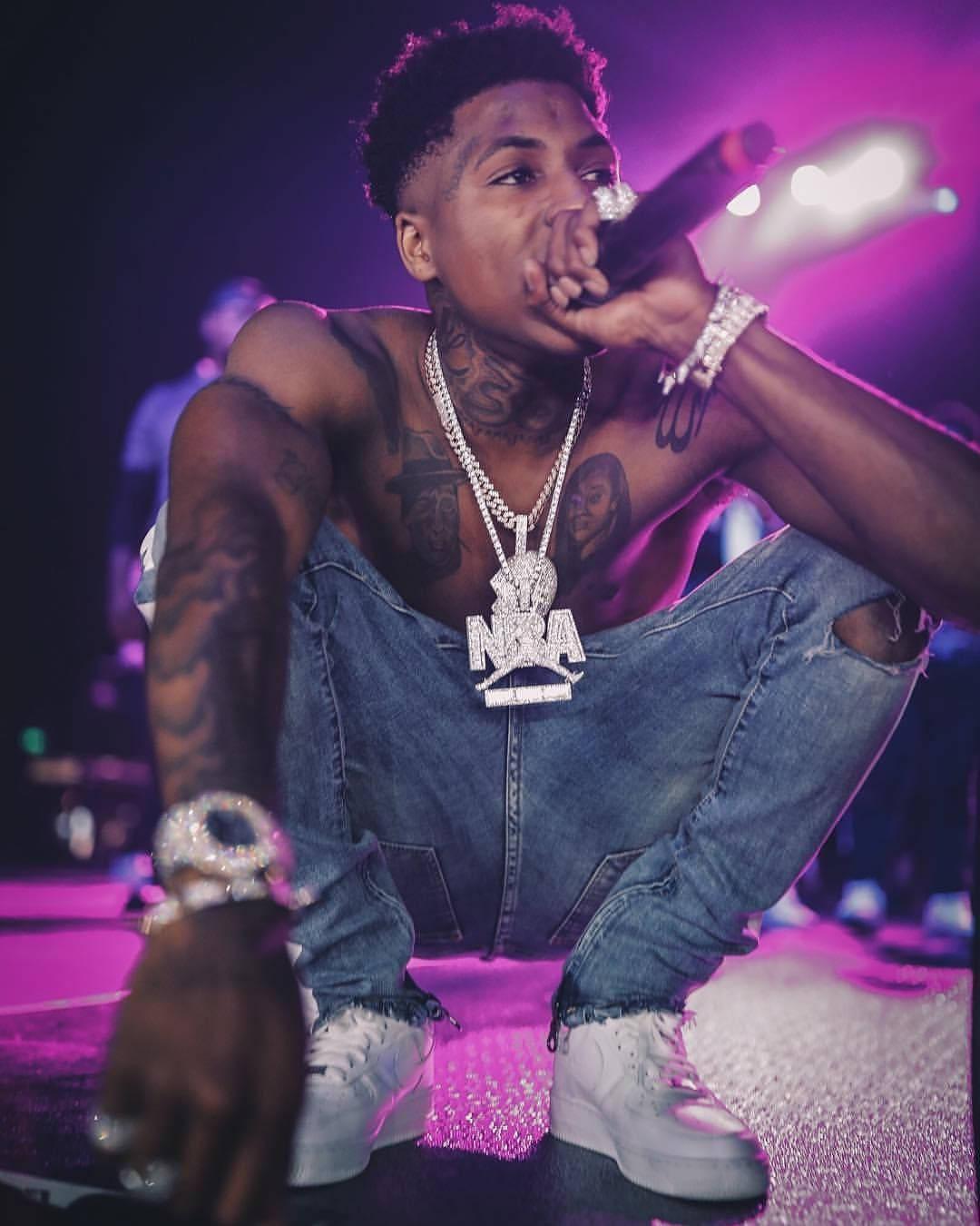 NBA Youngboy appearing on purple neon lights stage — 1080x1350 wallpaper