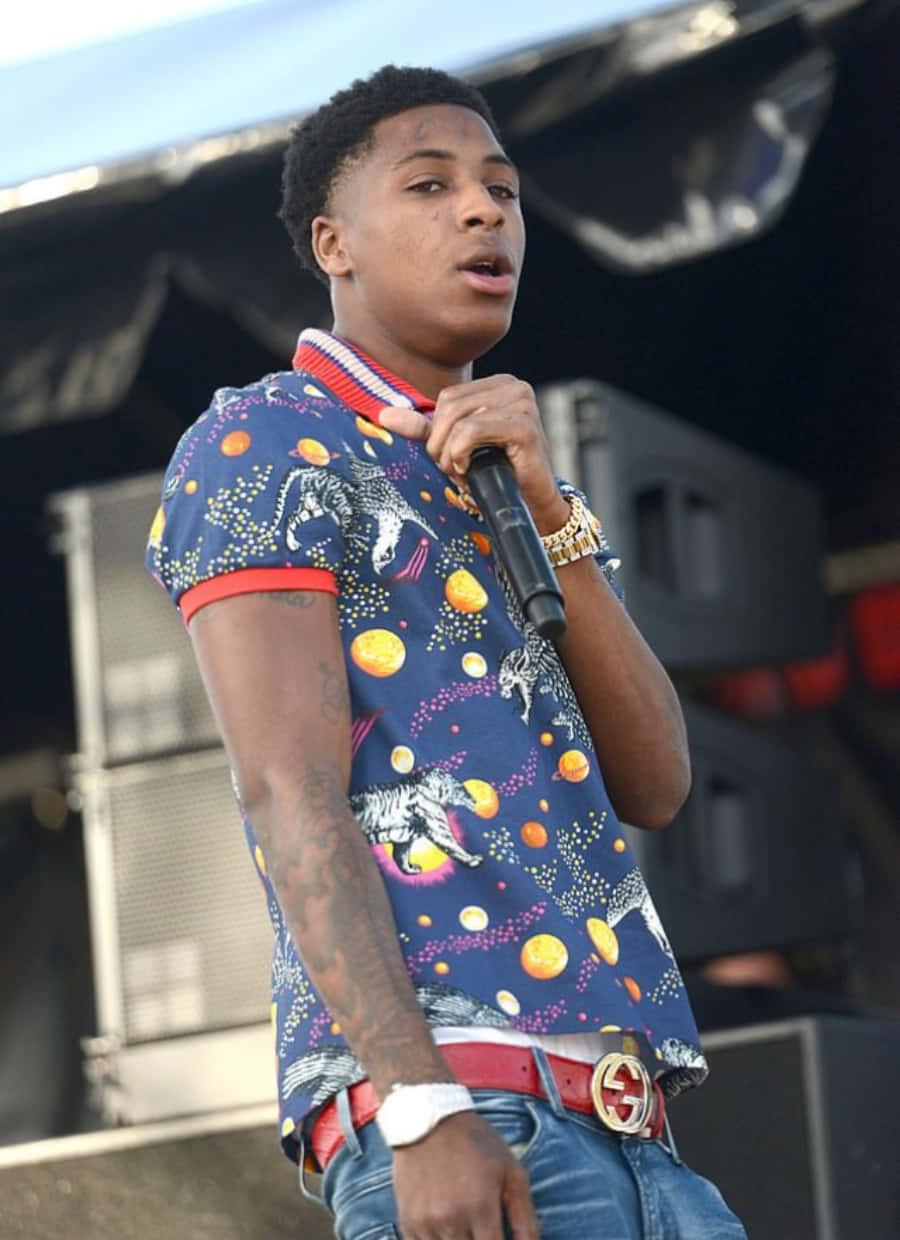 NBA Youngboy delighting his fans with an energetic performance — 900x1240 wallpaper